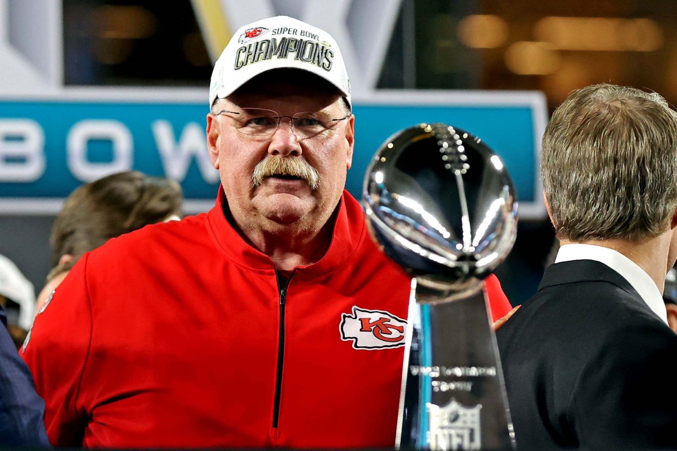 Kansas City Chiefs head coach Andy Reid looks at the Vince Lombardi Trophy after beating the San Francisco 49ers in Super Bowl LIV at Hard Rock Stadium.