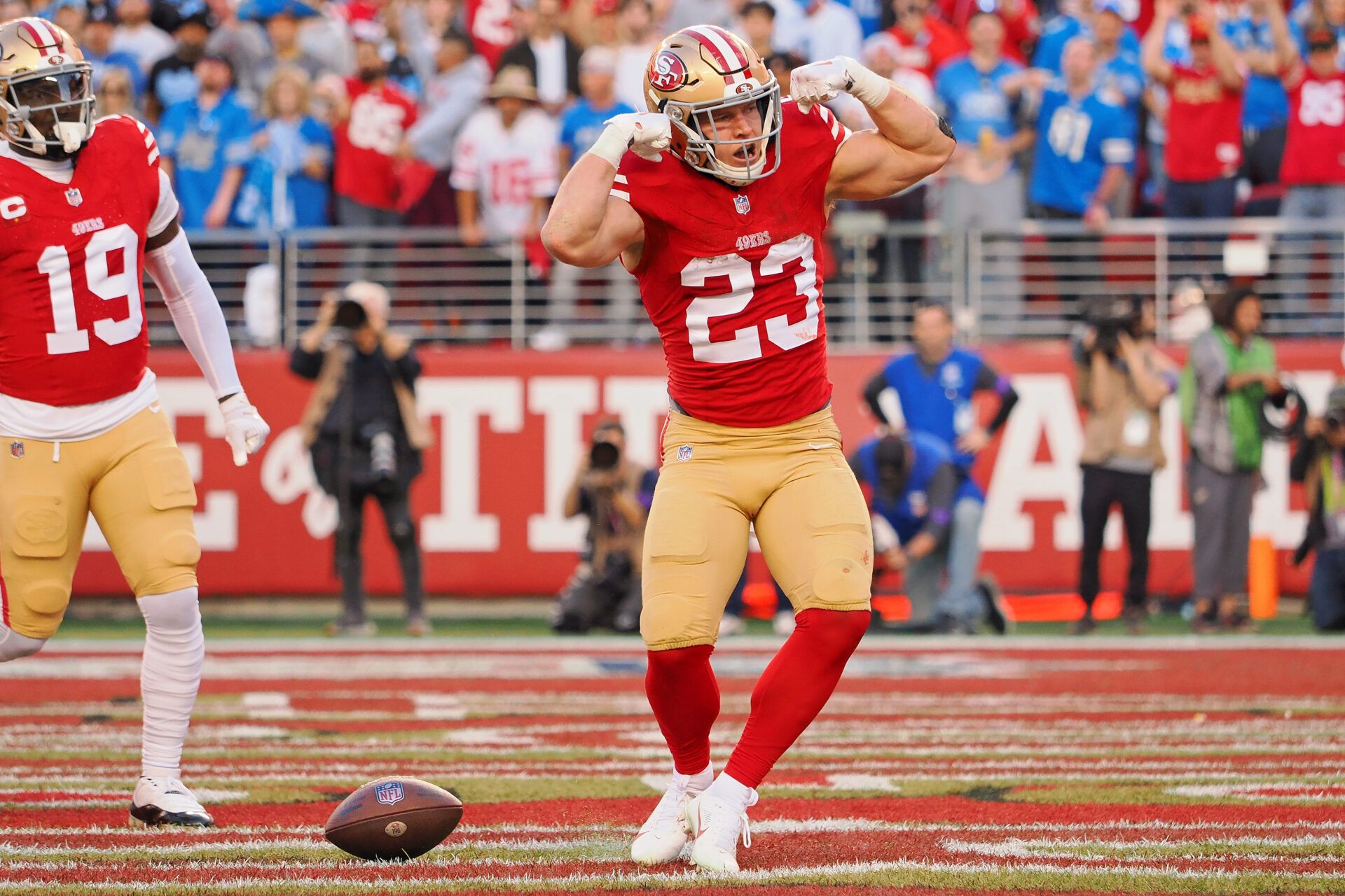 San Francisco 49ers running back Christian McCaffrey (23) celebrates after scoring a touchdown against the Detroit Lions during the first half of the NFC Championship football game at Levi's Stadium.