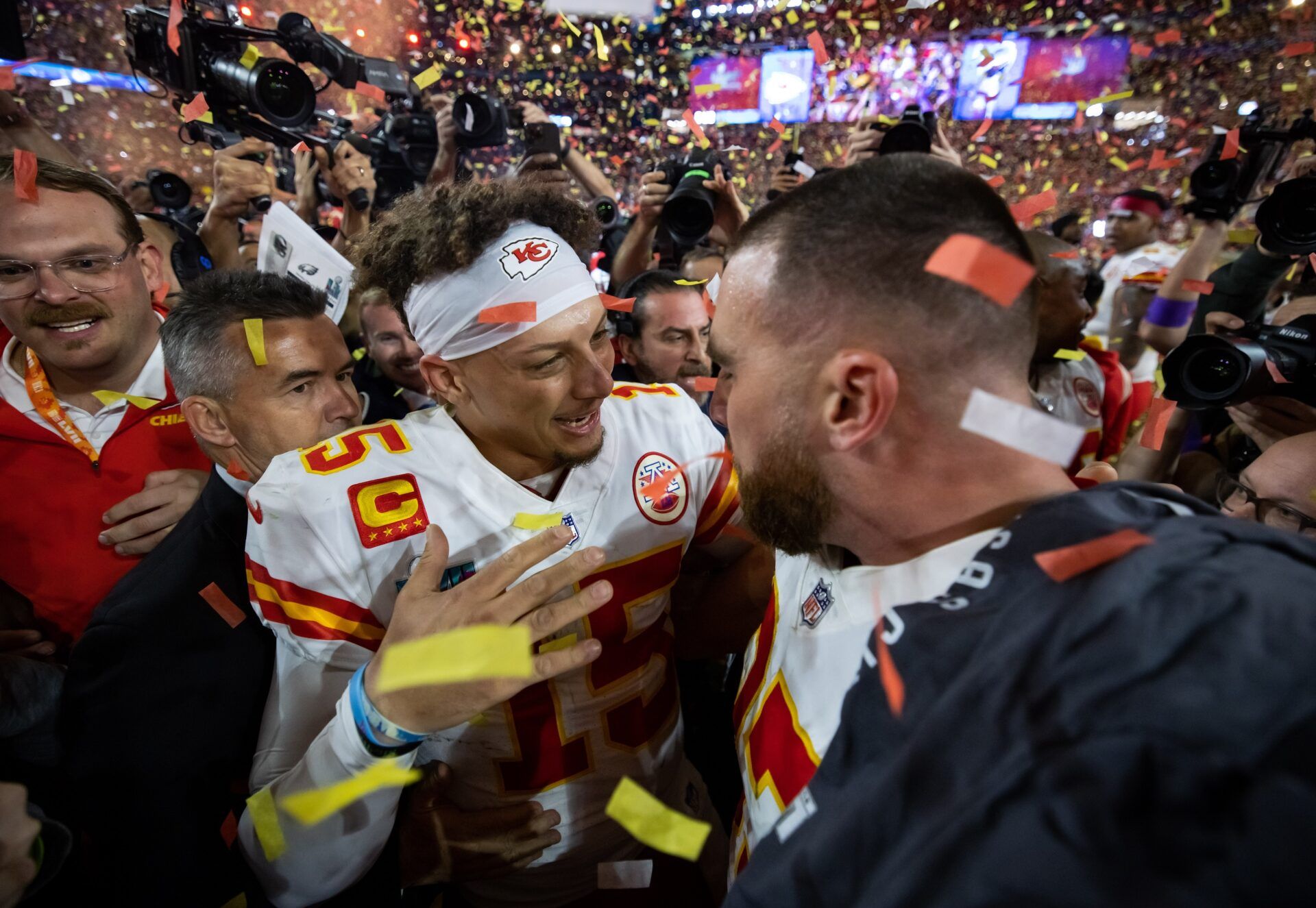 Kansas City Chiefs quarterback Patrick Mahomes (left) celebrates with tight end Travis Kelce after defeating the Philadelphia Eagles during Super Bowl LVII at State Farm Stadium.