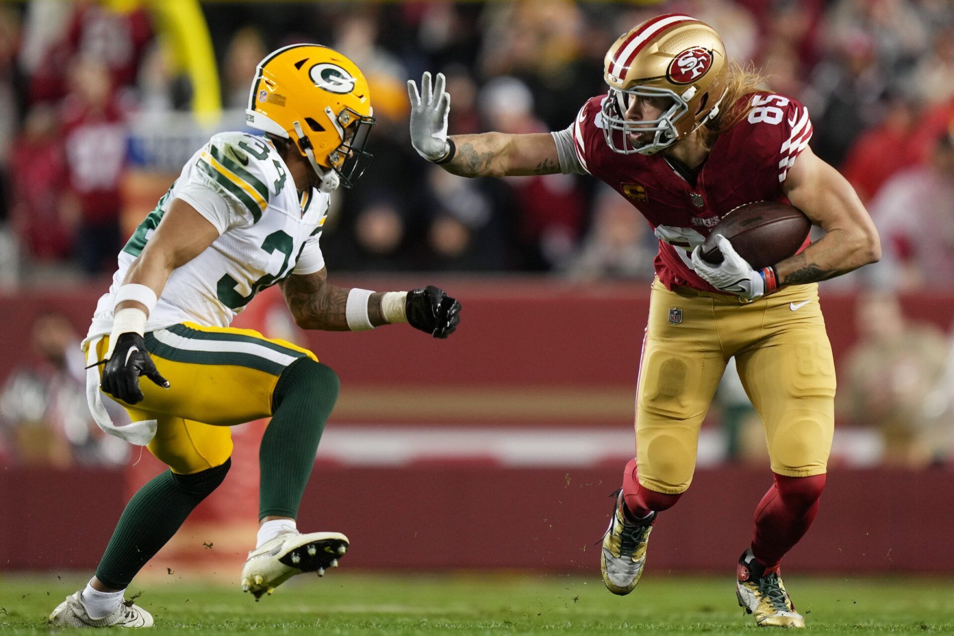San Francisco 49ers tight end George Kittle (85) runs against Green Bay Packers safety Jonathan Owens (34) during the third quarter in a 2024 NFC divisional round game at Levi's Stadium.