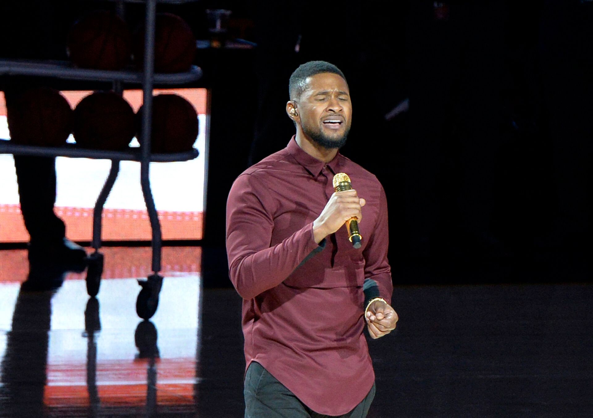 Recording artist Usher performs the national anthem prior to the game between the New York Knicks and the Cleveland Cavaliers at Quicken Loans Arena.