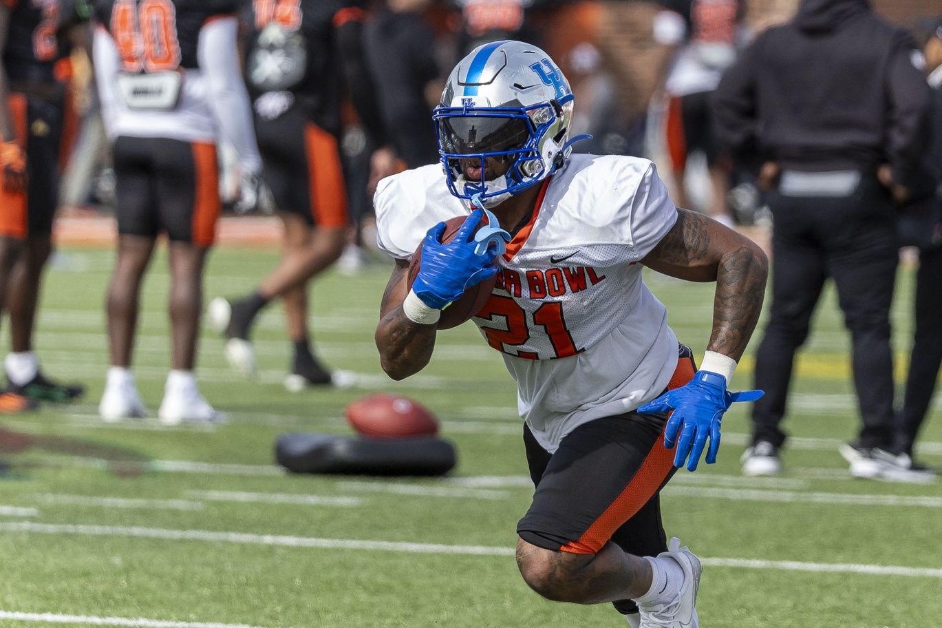 Ray Davis of Kentucky (21) works in running drills during practice for the American team at Hancock Whitney Stadium.