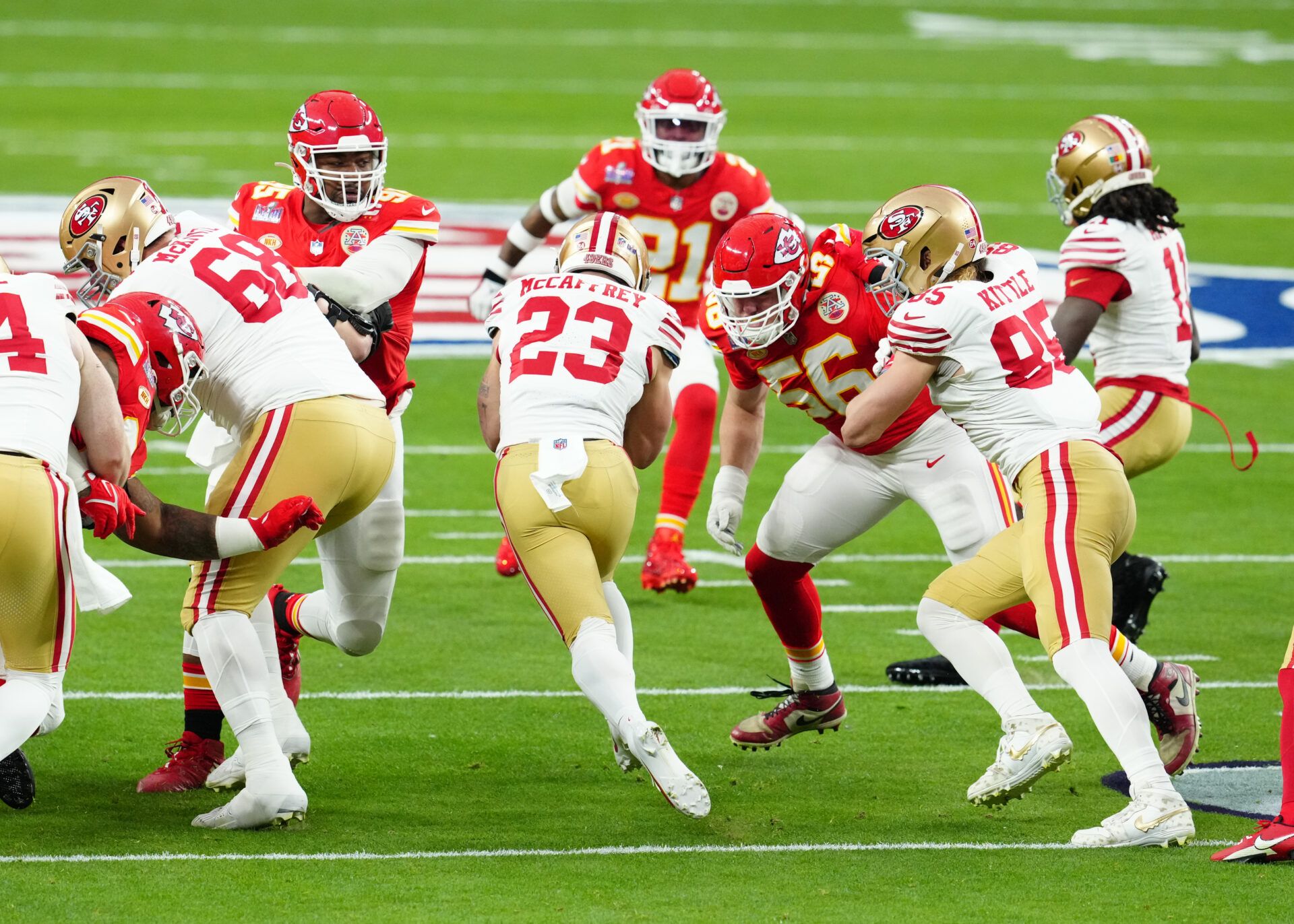 Feb 11, 2024; Paradise, Nevada, USA; San Francisco 49ers running back Christian McCaffrey (23) runs against Kansas City Chiefs defensive end George Karlaftis (56) in the first quarter in Super Bowl LVIII at Allegiant Stadium. Mandatory Credit: Stephen R. Sylvanie-USA TODAY Sports