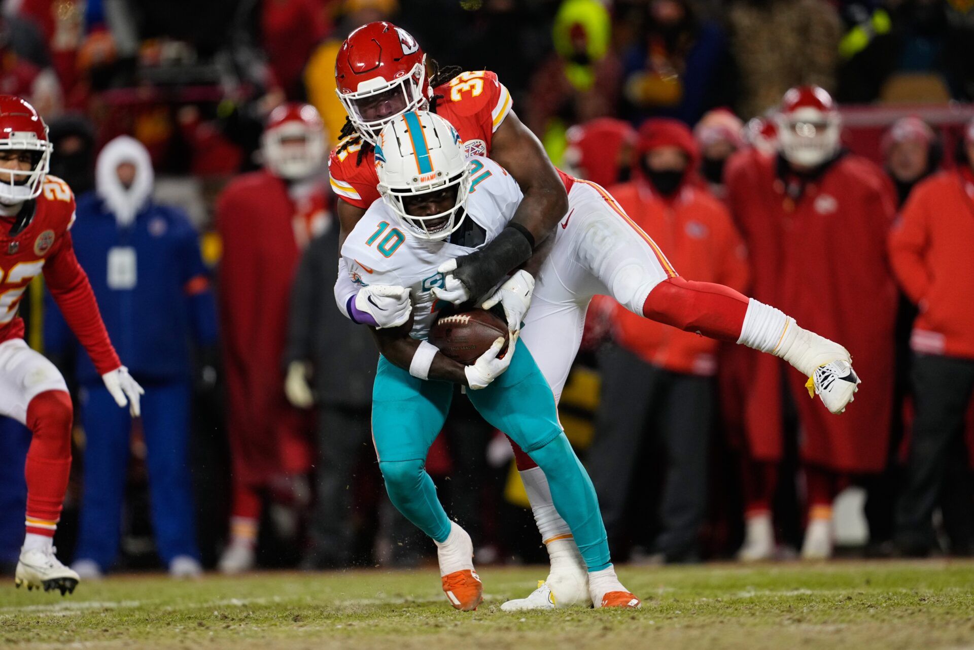 Miami Dolphins wide receiver Tyreek Hill (10) is brought down by Kansas City Chiefs linebacker Nick Bolton (32) during the second half of the 2024 AFC wild card game at GEHA Field at Arrowhead Stadium.