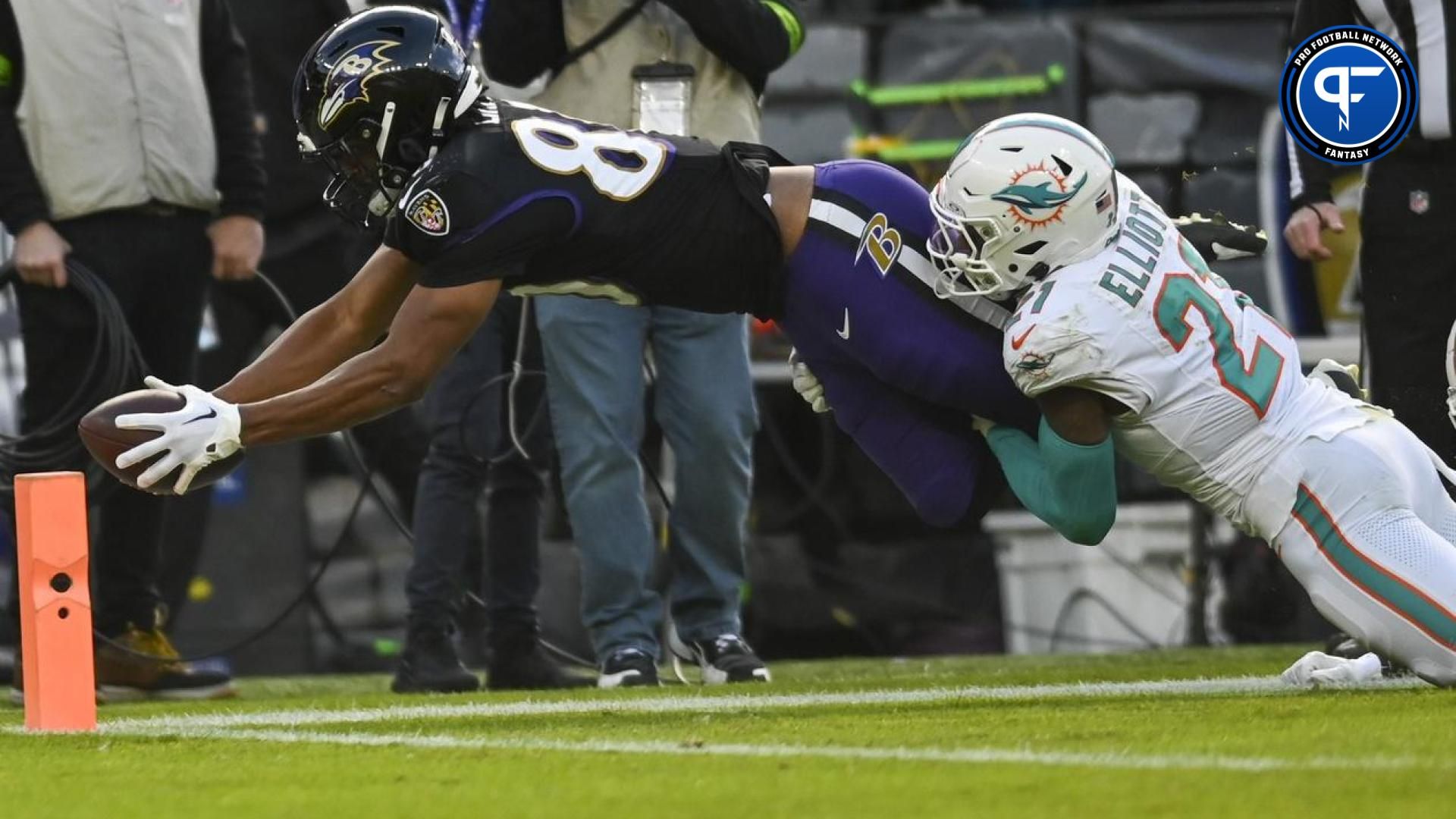 Baltimore Ravens tight end Isaiah Likely (80) dives for a touchdown as Miami Dolphins safety DeShon Elliott (21) defends during the first half at M&T Bank Stadium.