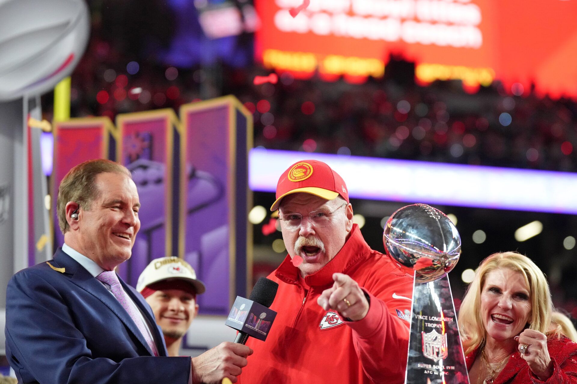Kansas City Chiefs head coach Andy Reid celebrates while being interviewed by CBS commentator Jim Nantz after winning Super Bowl LVIII against the San Francisco 49ers at Allegiant Stadium.