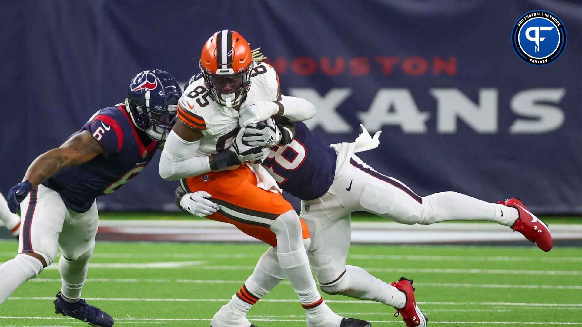 Cleveland Browns tight end David Njoku (85) is tackled by Cleveland Browns safety Tanner McCalister (48) in a 2024 AFC wild card game at NRG Stadium.