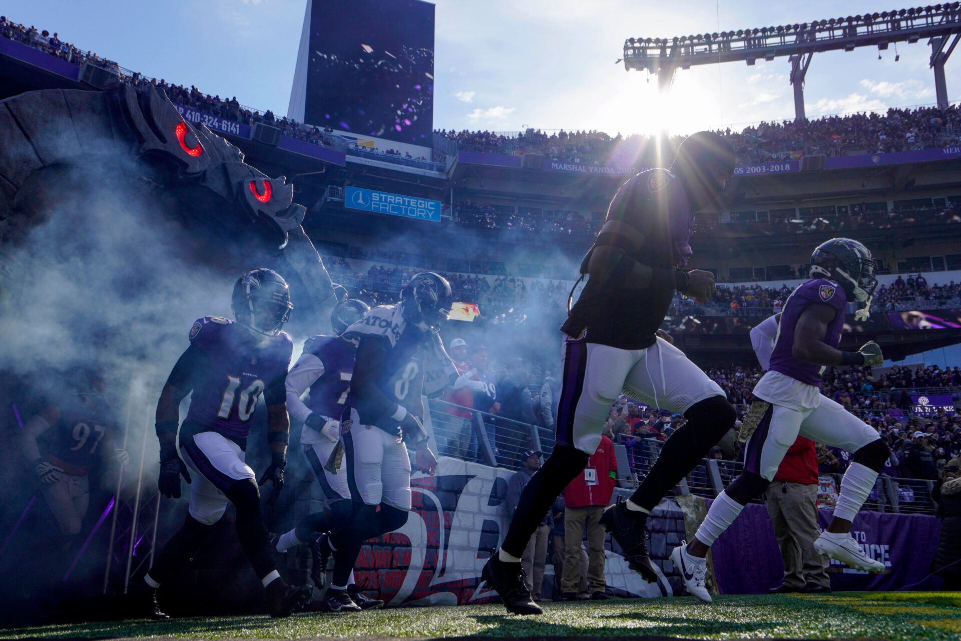 Baltimore Ravens quarterback Lamar Jackson (8) takes the field with teammates, including cornerback Arthur Maulet (10), before a game against the Cleveland Browns at M&T Bank Stadium.