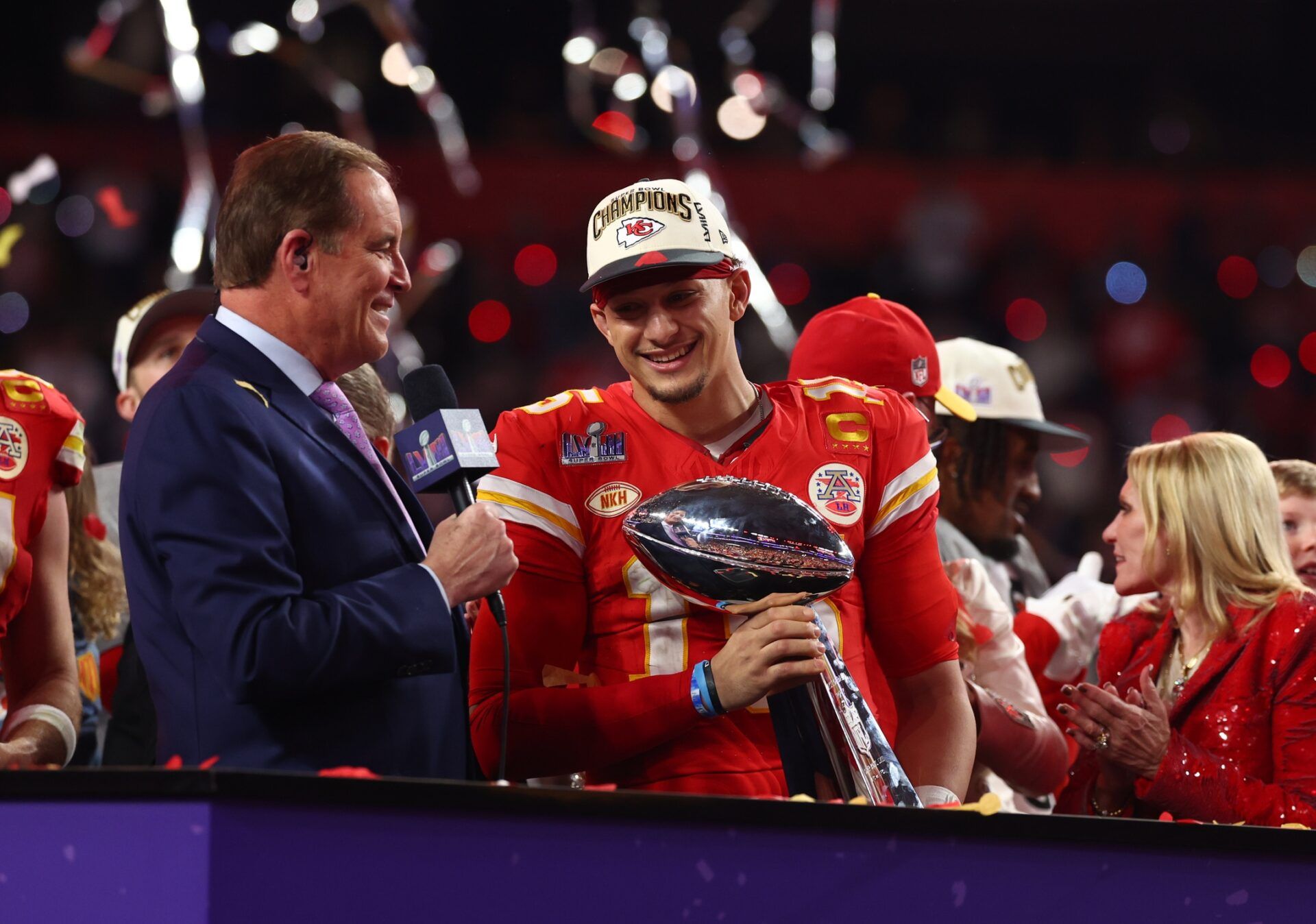 Kansas City Chiefs QB Patrick Mahomes holds the Lombardi Trophy with Jim Nantz.