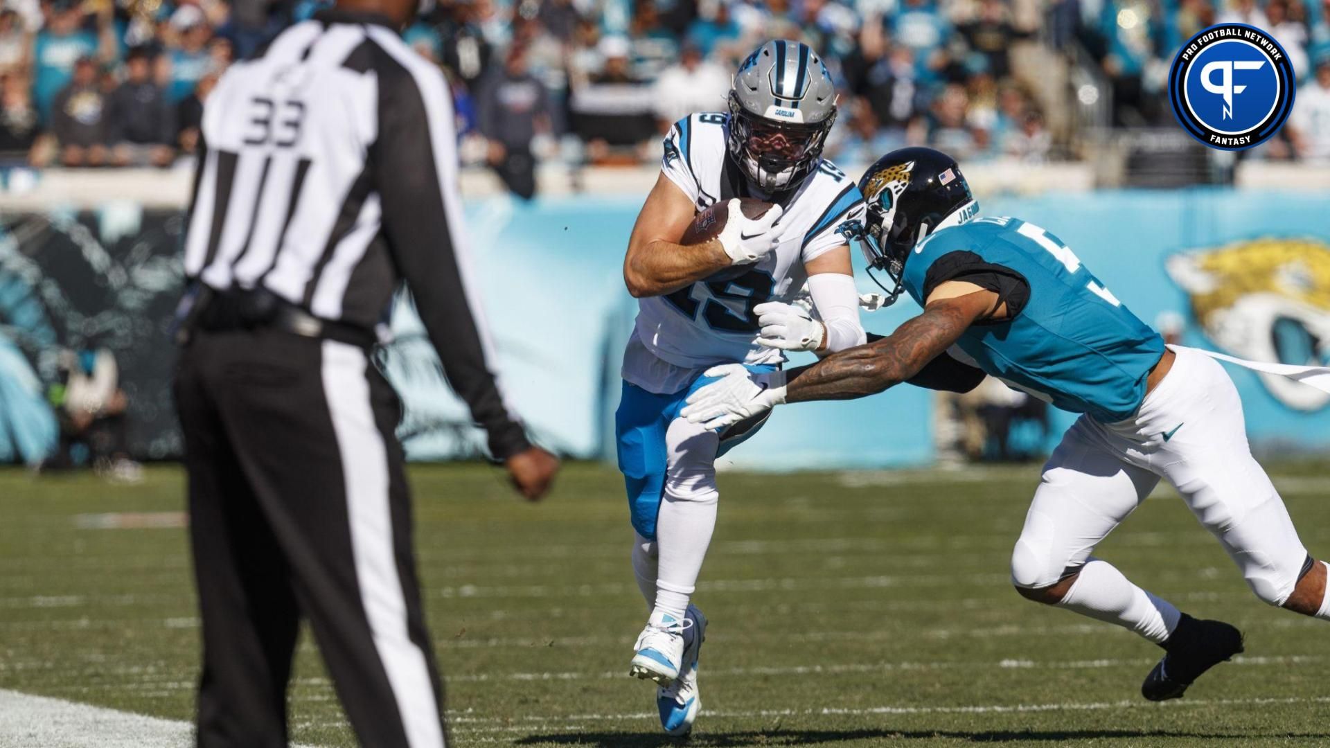 Jacksonville Jaguars safety Andre Cisco (5) tackles Carolina Panthers wide receiver Adam Thielen (19) during the first quarter at EverBank Stadium.