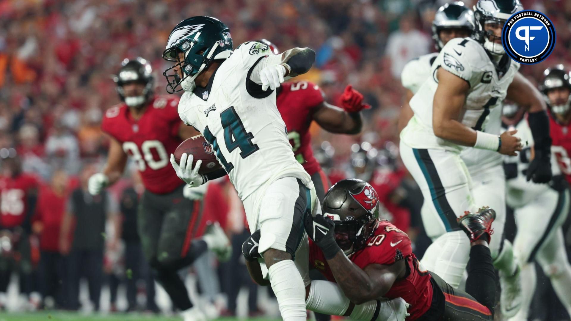 Philadelphia Eagles running back Kenneth Gainwell (14) is tackled by Tampa Bay Buccaneers linebacker Lavonte David (54) during the second half of a 2024 NFC wild card game at Raymond James Stadium.