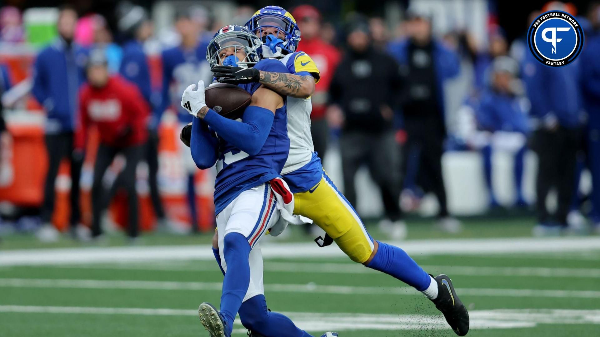 New York Giants wide receiver Jalin Hyatt (13) catches a pass against Los Angeles Rams cornerback Cobie Durant (14) during the fourth quarter at MetLife Stadium. The play was negated by an offensive holding penalty.