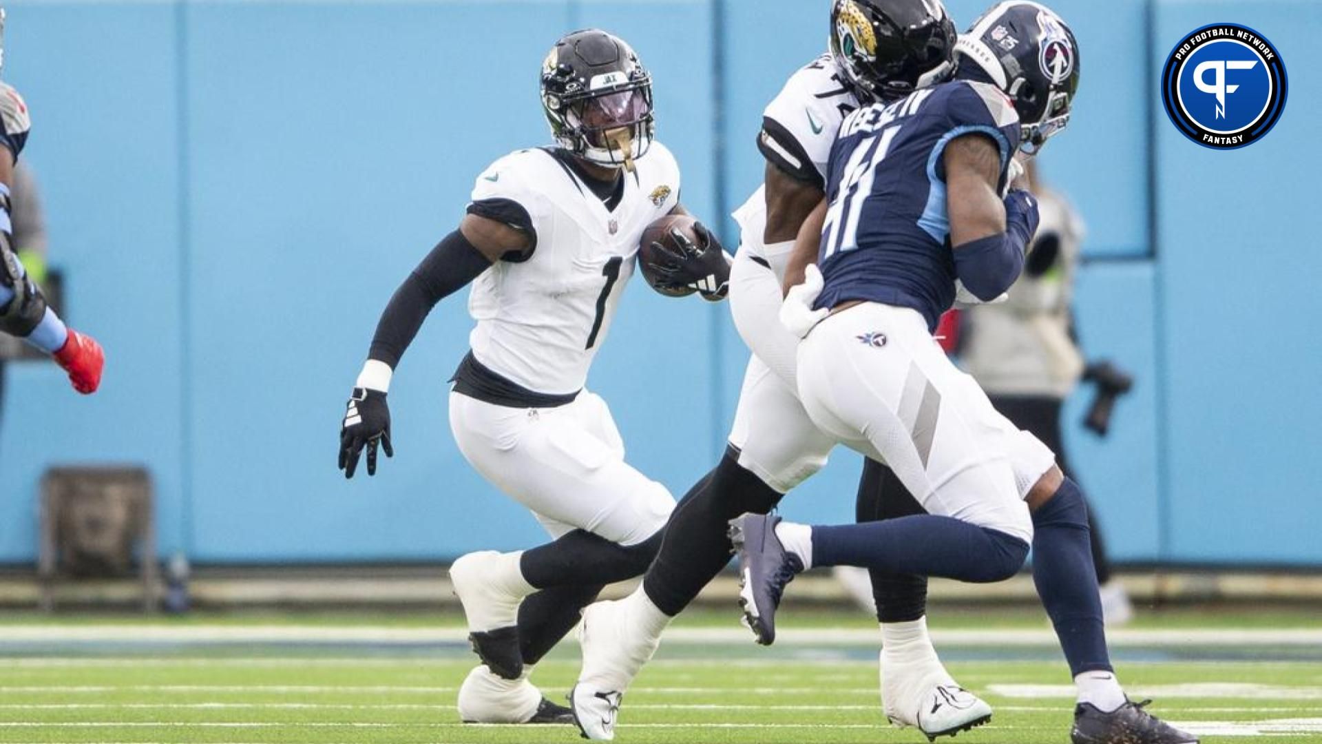 Jacksonville Jaguars running back Travis Etienne Jr. (1) runs the ball against the Tennessee Titans during the first half at Nissan Stadium.