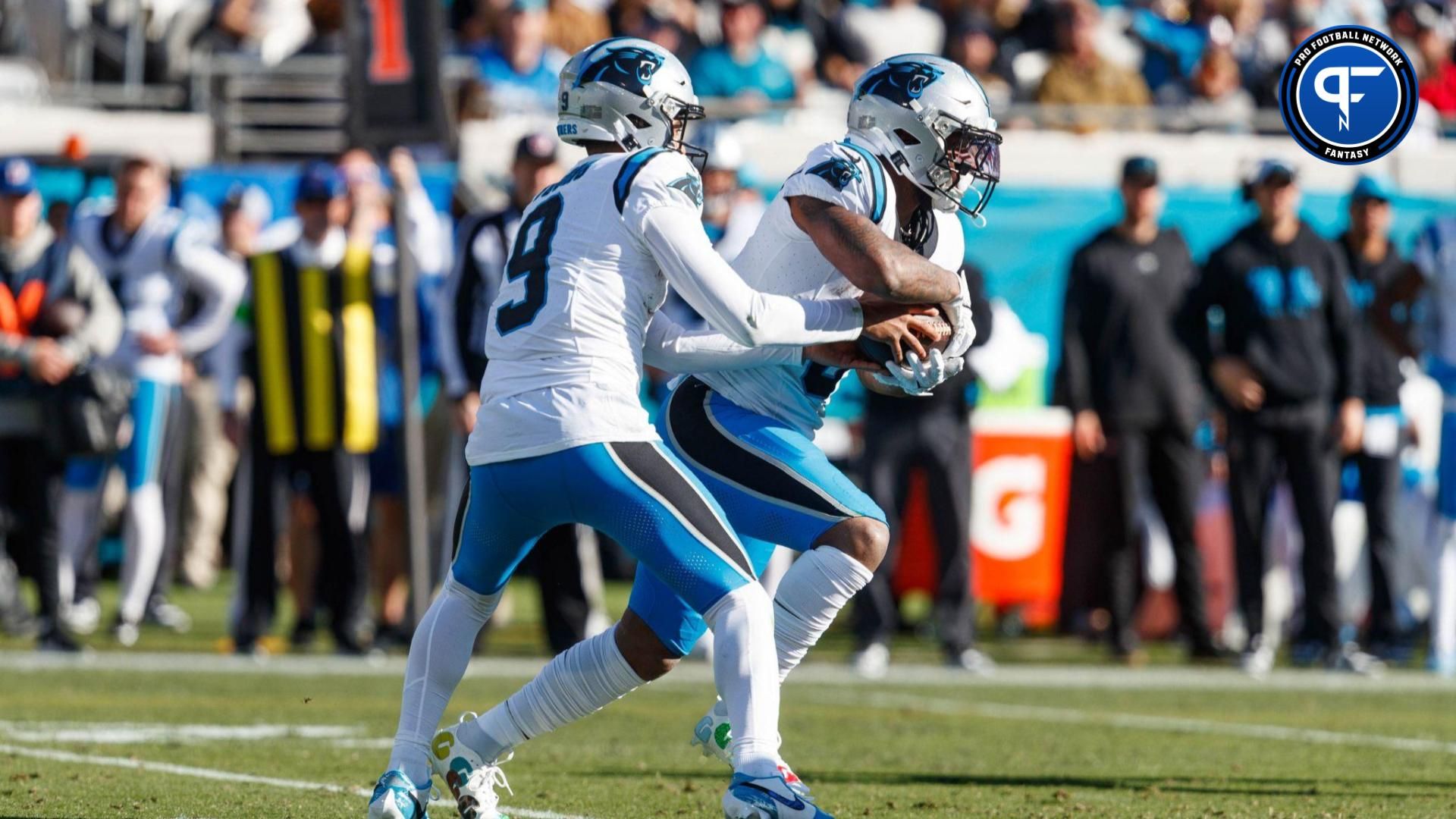 Carolina Panthers quarterback Bryce Young (9) hands the ball to running back Miles Sanders (6) against the Jacksonville Jaguars during the third quarter at EverBank Stadium.