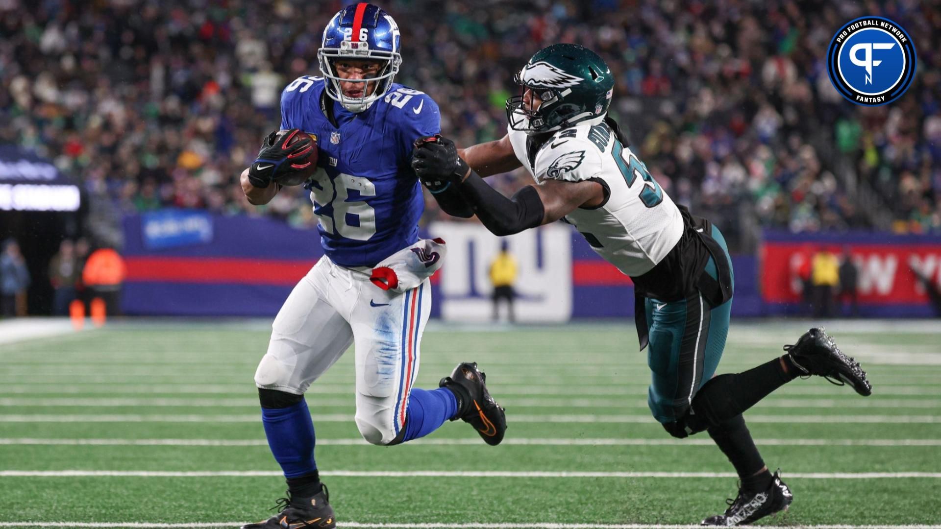 New York Giants running back Saquon Barkley (26) breaks a tackle by Philadelphia Eagles linebacker Zach Cunningham (52) for a rushing touchdown during the first half at MetLife Stadium.