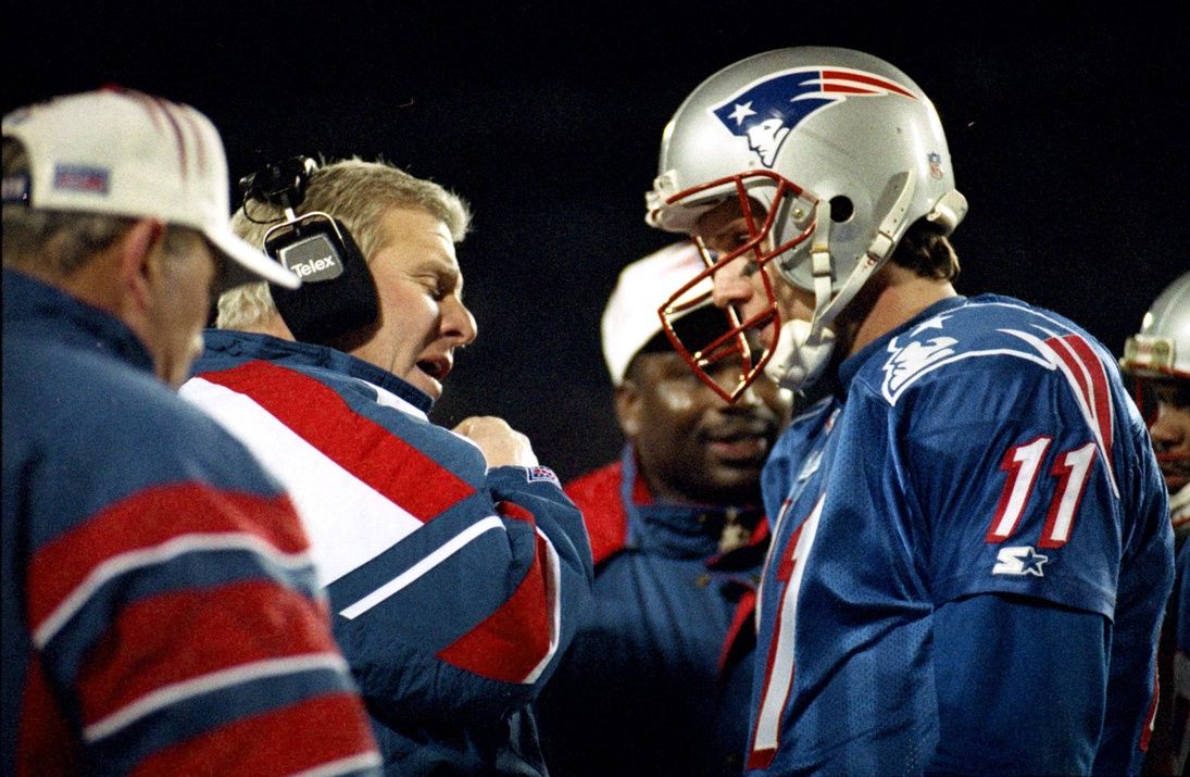 New England Patriots head coach Bill Parcells confers on the sideline with quarterback Drew Bledsoe (11) during a game.