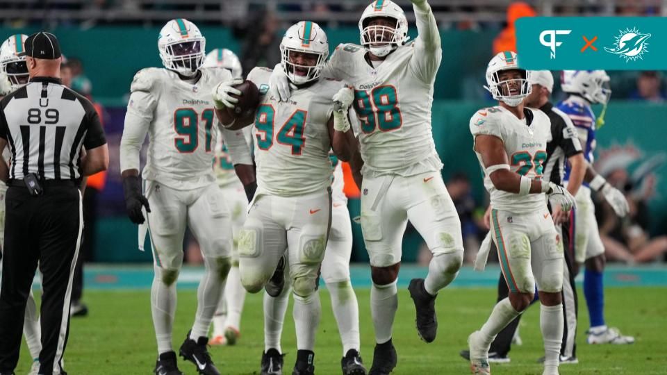 Miami Dolphins players celebrate a fumble recovery against the Buffalo Bills.