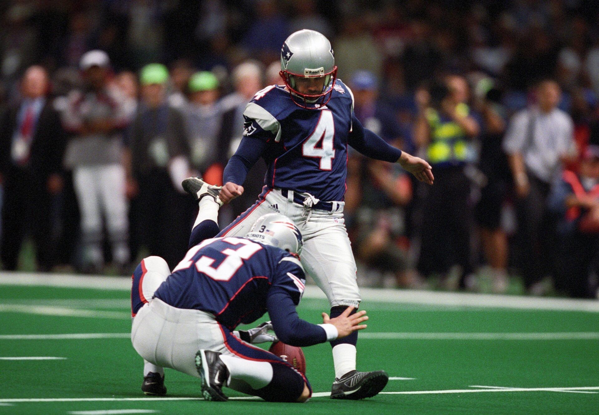 New England Patriots kicker Adam Vinatieri (4) kicks the ball against the St. Louis Rams during Super Bowl XXXVI at the Louisiana Superdome.