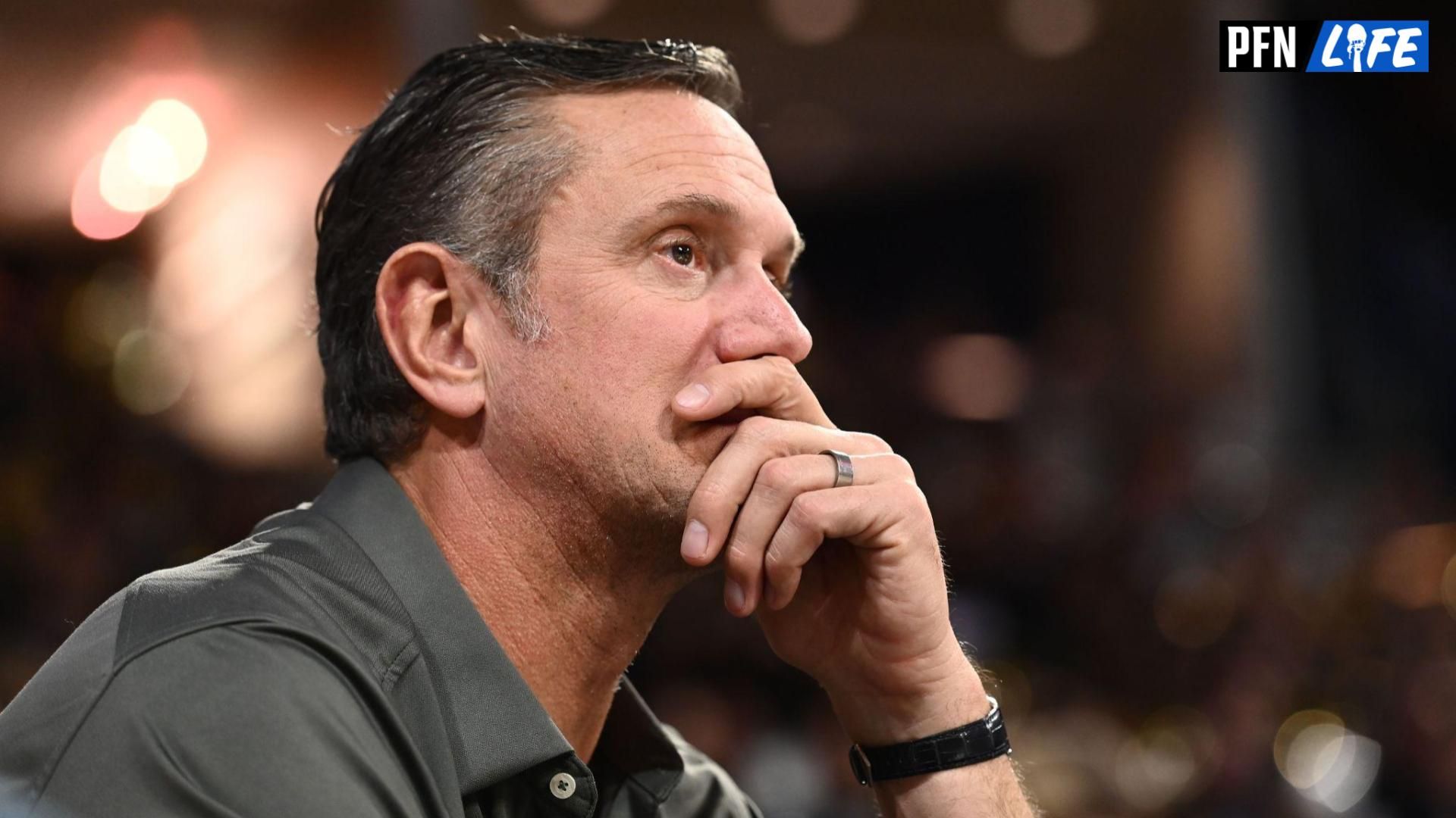 Former New England Patriots quarterback Drew Bledsoe looks on during a college basketball game.