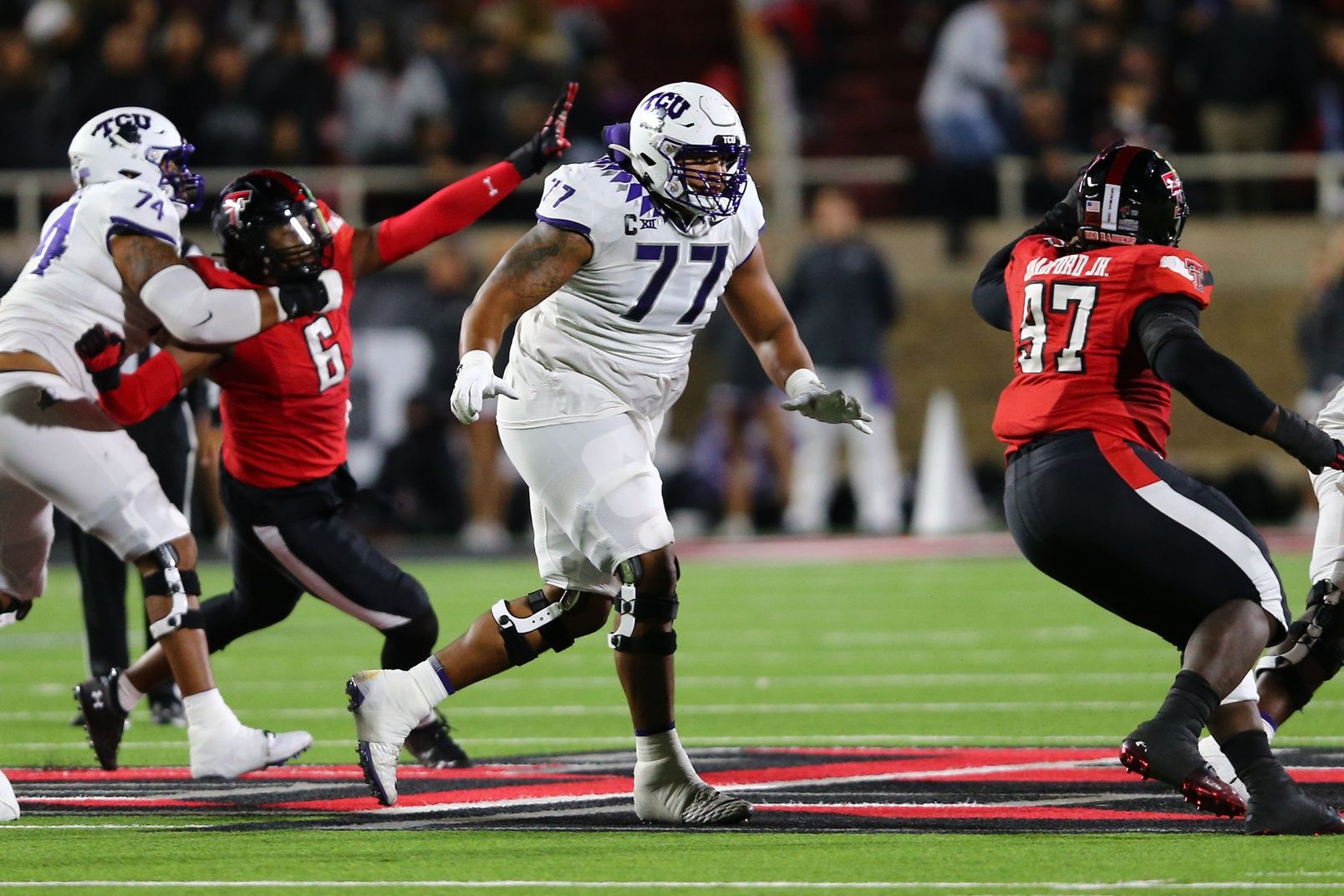 Texas Christian Horned Frogs offensive tackle Brandon Coleman (77) blocks Texas Tech Red Raiders defensive tackle Tony Bradford Jr. (97) in the second half at Jones AT&T Stadium and Cody Campbell Field.