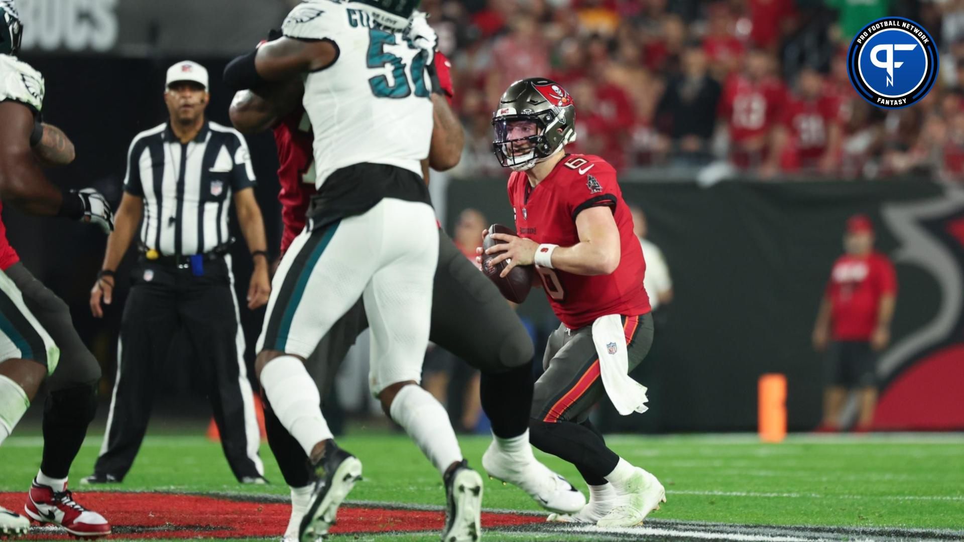 Tampa Bay Buccaneers quarterback Baker Mayfield (6) scrambles against the Philadelphia Eagles during the first half of a 2024 NFC wild card game at Raymond James Stadium.