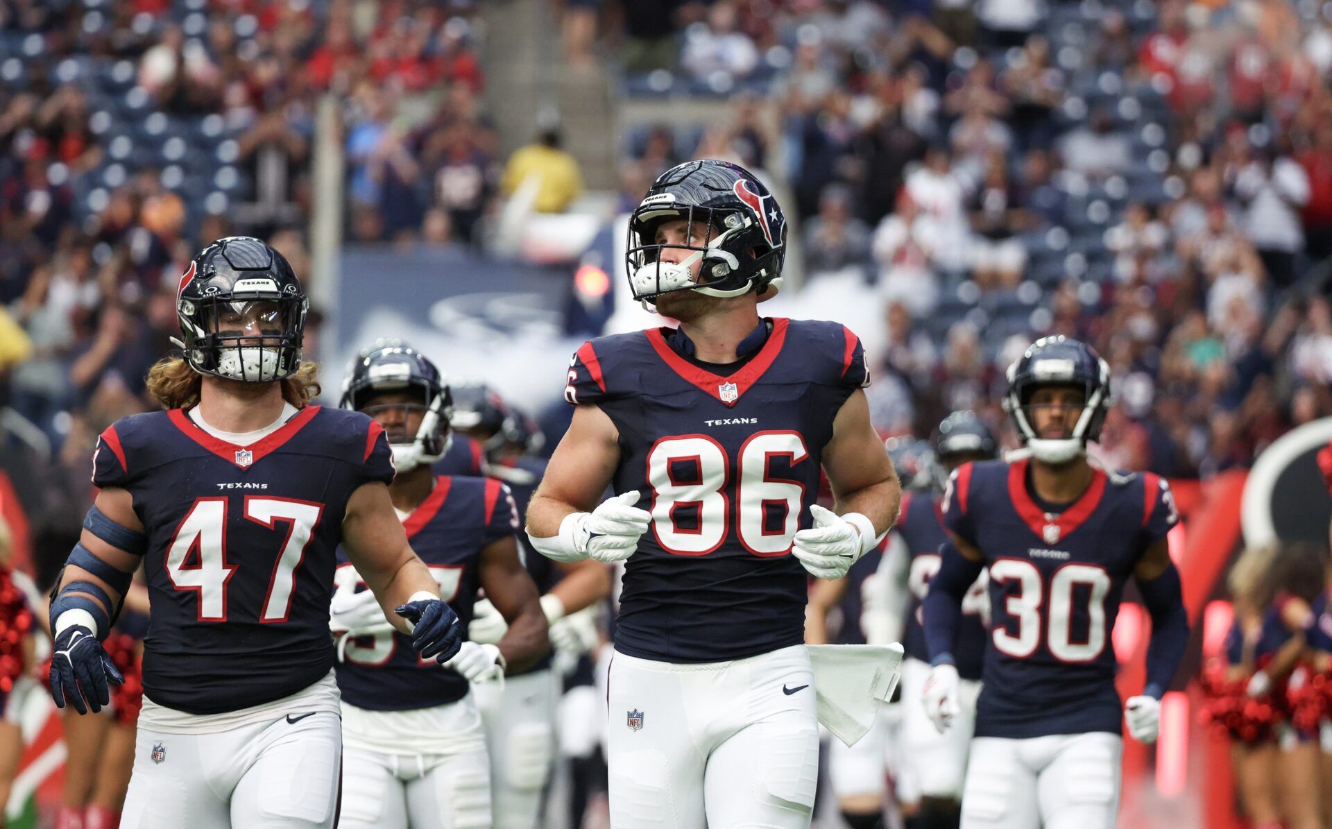 Houston Texans tight end Dalton Schultz (86) and teammates run onto the field before playing against the Tampa Bay Buccaneers at NRG Stadium.