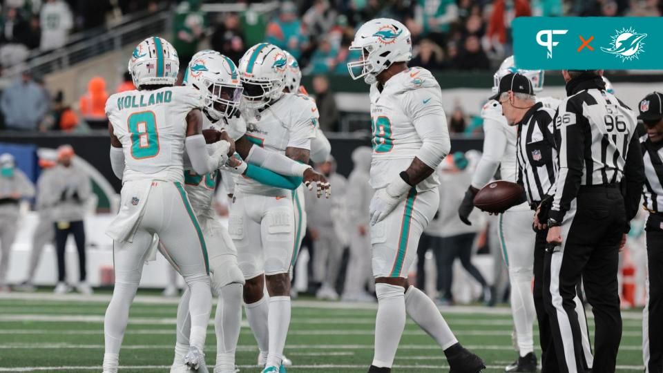 Miami Dolphins linebacker Jerome Baker (55) celebrates with teammates after an interception during the second half against the New York Jets at MetLife Stadium.