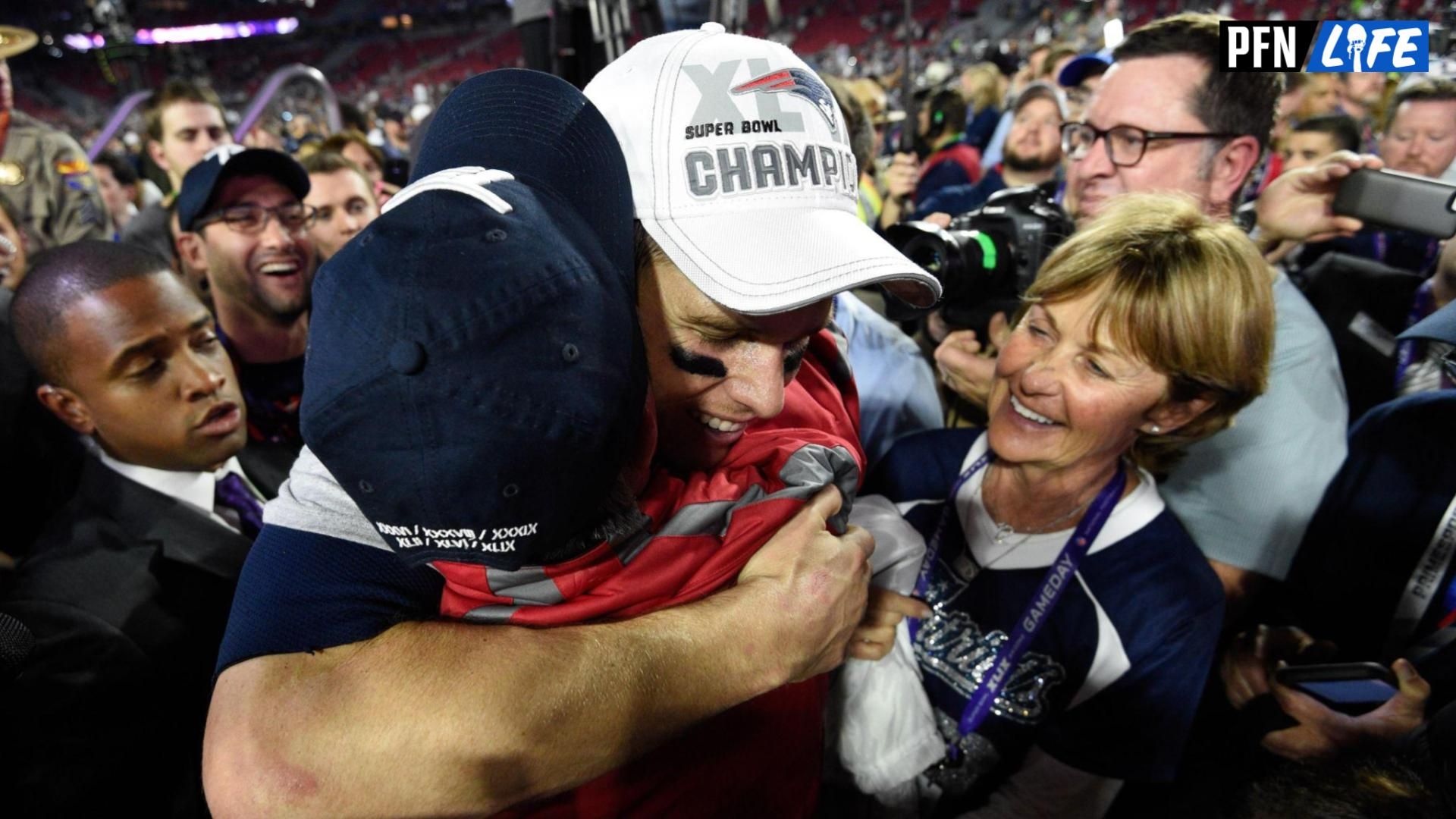 New England Patriots quarterback Tom Brady (12) hugs a family member as mother Galynn Brady (right) looks on after Super Bowl XLIX against the Seattle Seahawks at University of Phoenix Stadium. The Patriots defeated the Seahawks 28-24.