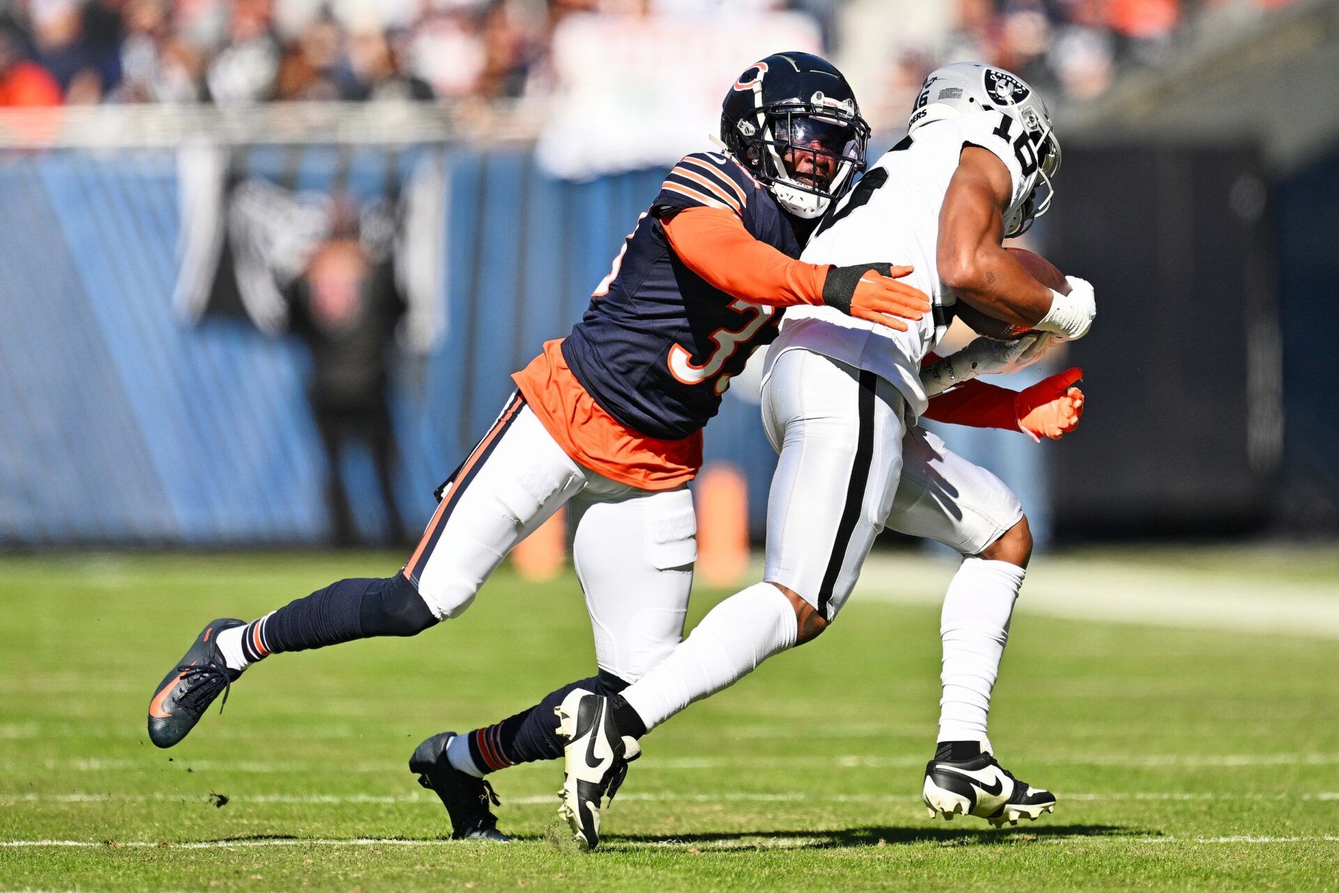 Chicago Bears CB Jaylon Johnson (33) tackles Las Vegas Raiders WR Jakobi Meyers (16).