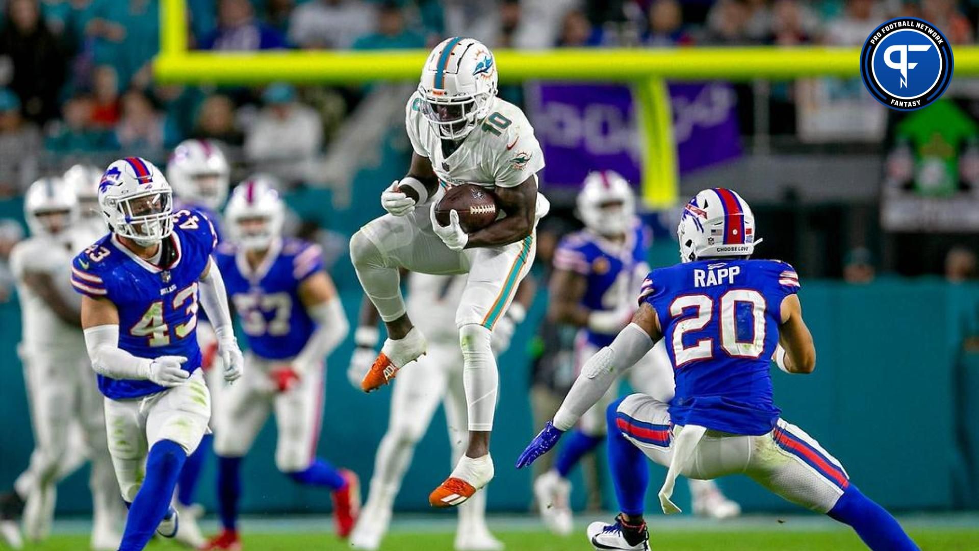 Miami Dolphins wide receiver Tyreek Hill (10), leaps to make a catch for a first down in front of Buffalo Bills safety Taylor Rapp (20), during second half action of their NFL football game Jan 07, 2024, in Miami Gardens.