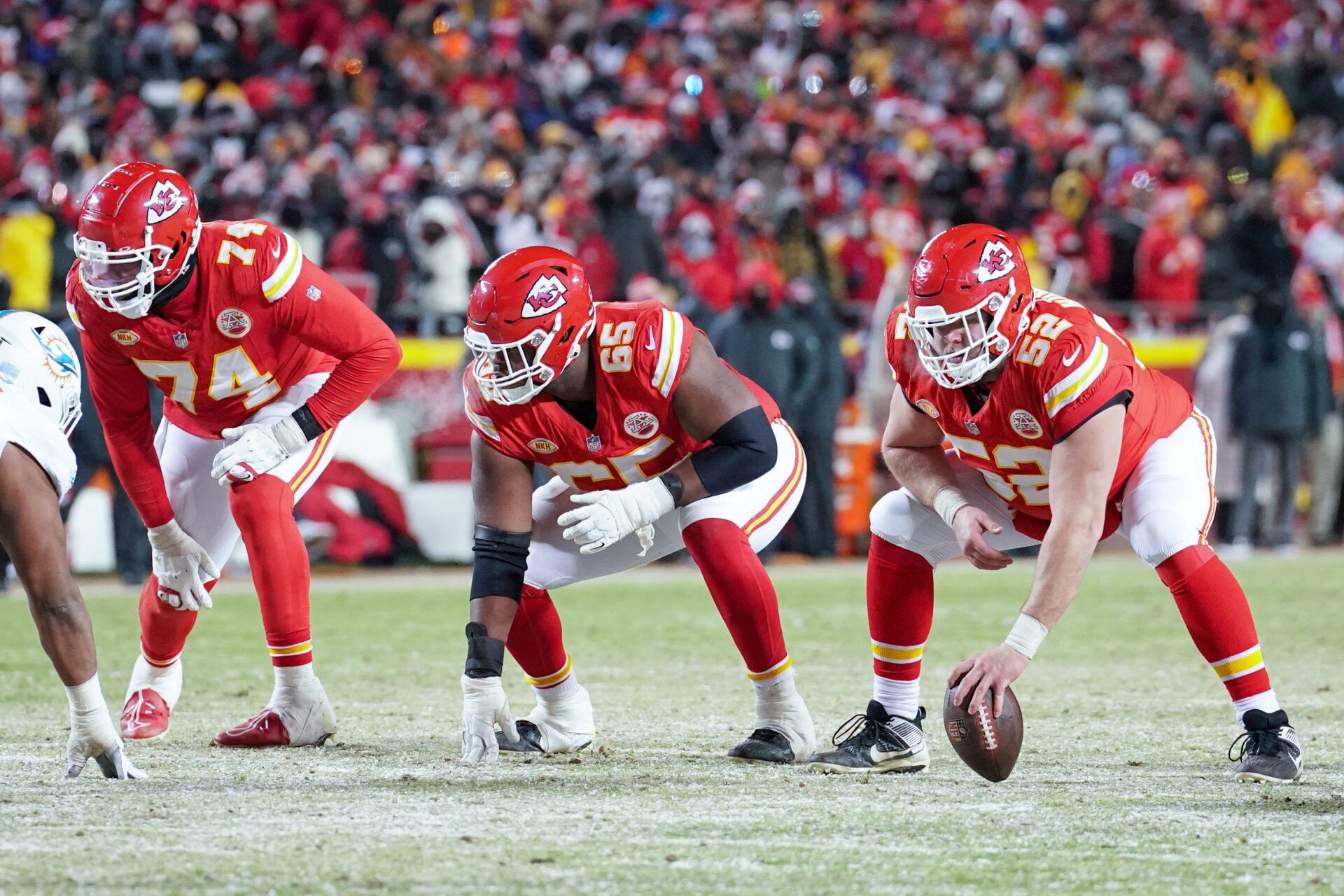 Kansas City Chiefs offensive tackle Jawaan Taylor (74) and guard Trey Smith (65) and center Creed Humphrey (52) at the line of scrimmage against the Miami Dolphins in a 2024 AFC wild card game at GEHA Field at Arrowhead Stadium.