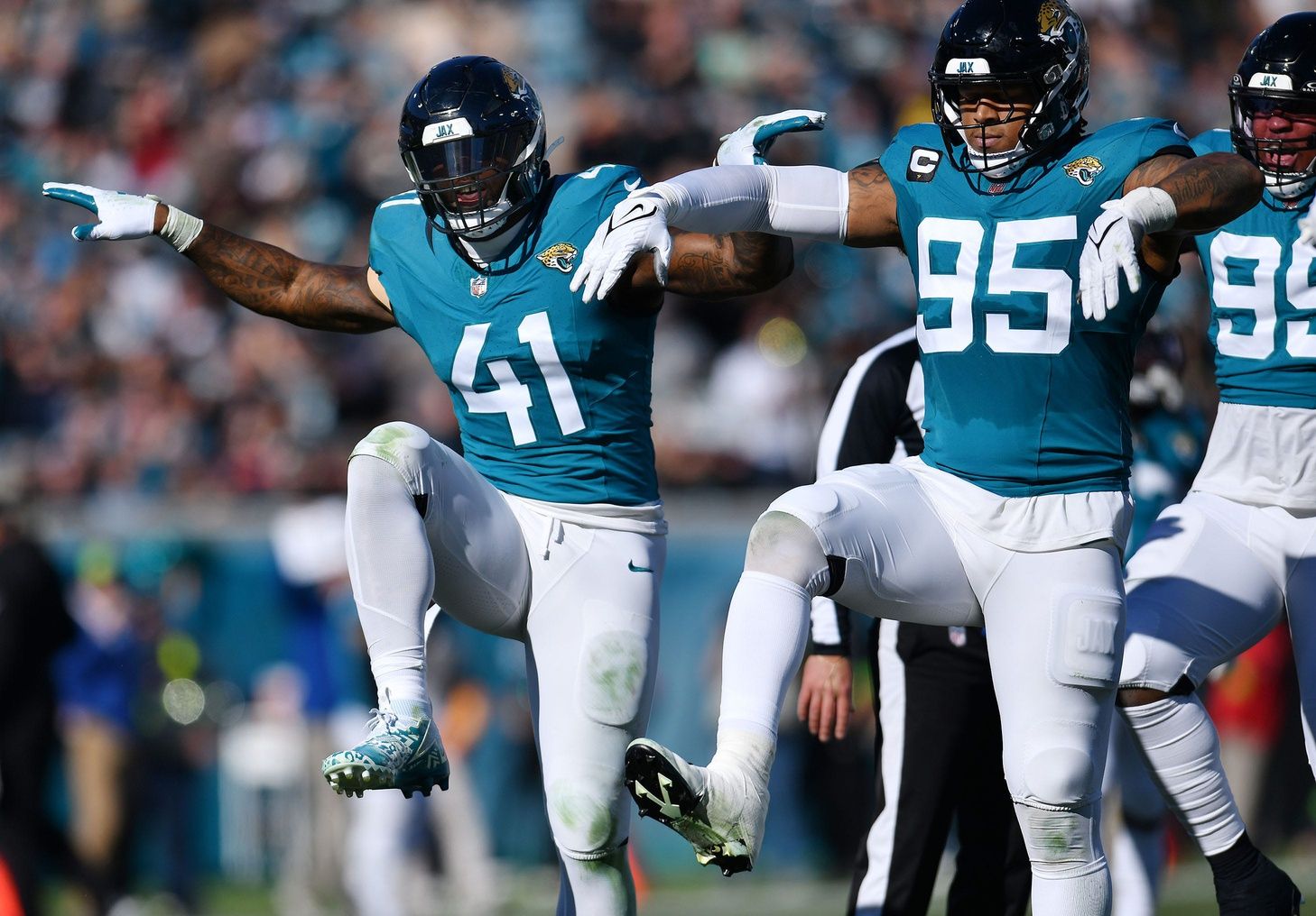 Jacksonville Jaguars linebacker Josh Allen (41) celebrates with teammates after setting the Jaguars single season record for sacks during second quarter action.