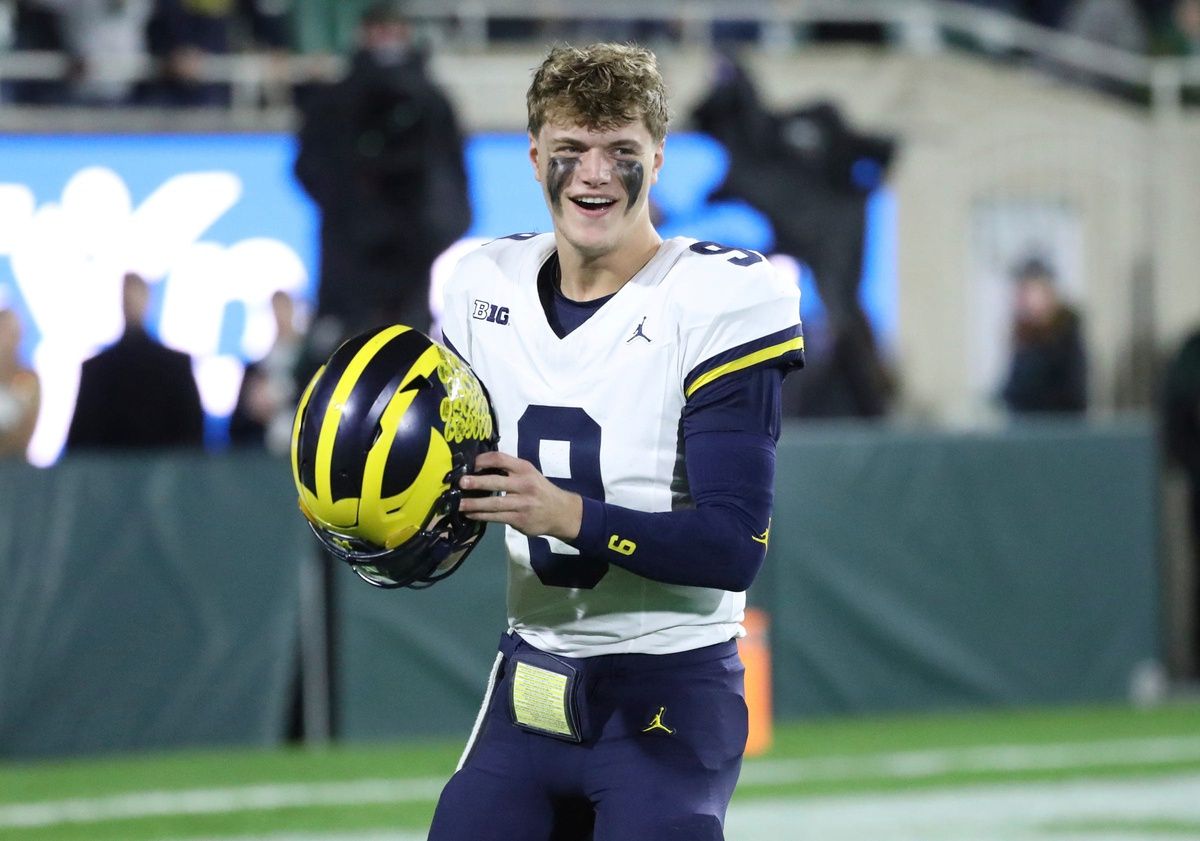 J.J. McCarthy (9) takes the field before action against the Michigan State Spartans at Spartan Stadium.