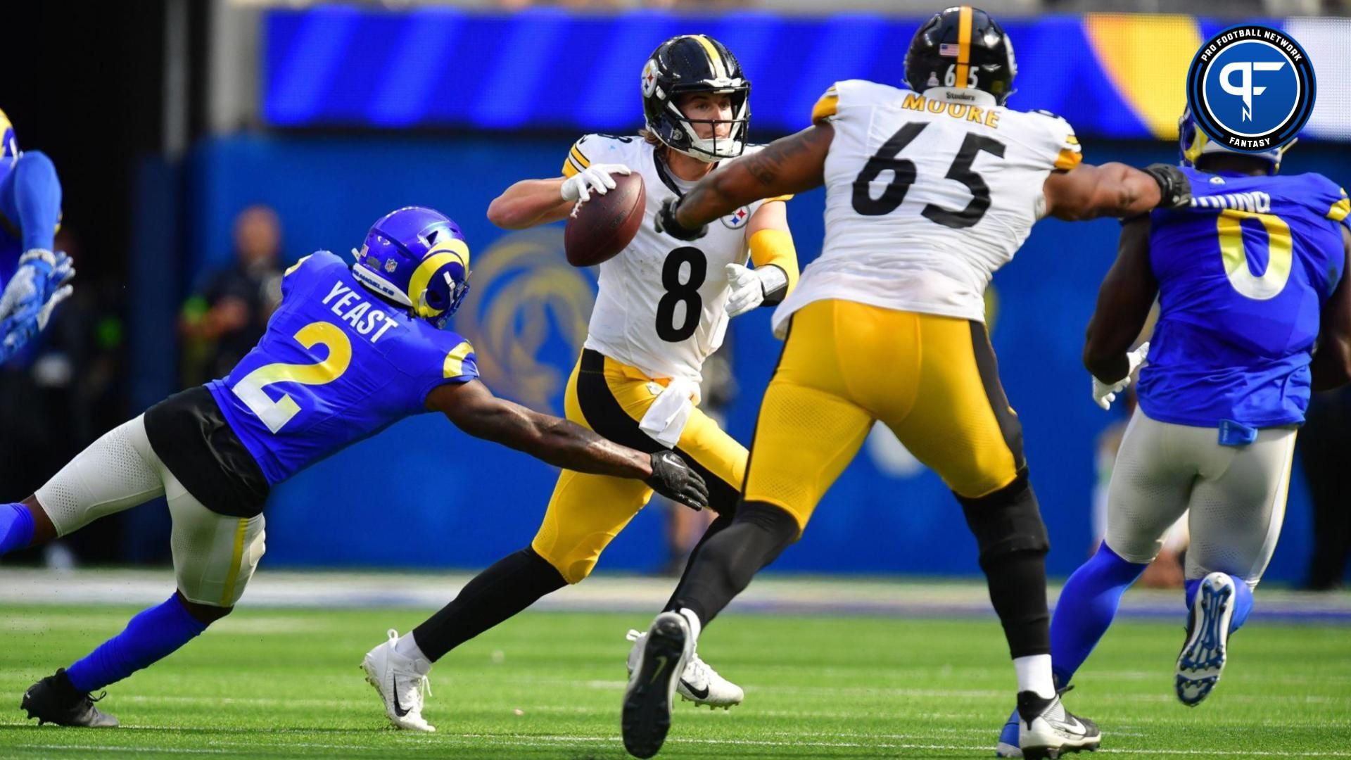 Pittsburgh Steelers quarterback Kenny Pickett (8) runs out to pass as Los Angeles Rams safety Russ Yeast (2) moves in during the first half at SoFi Stadium.