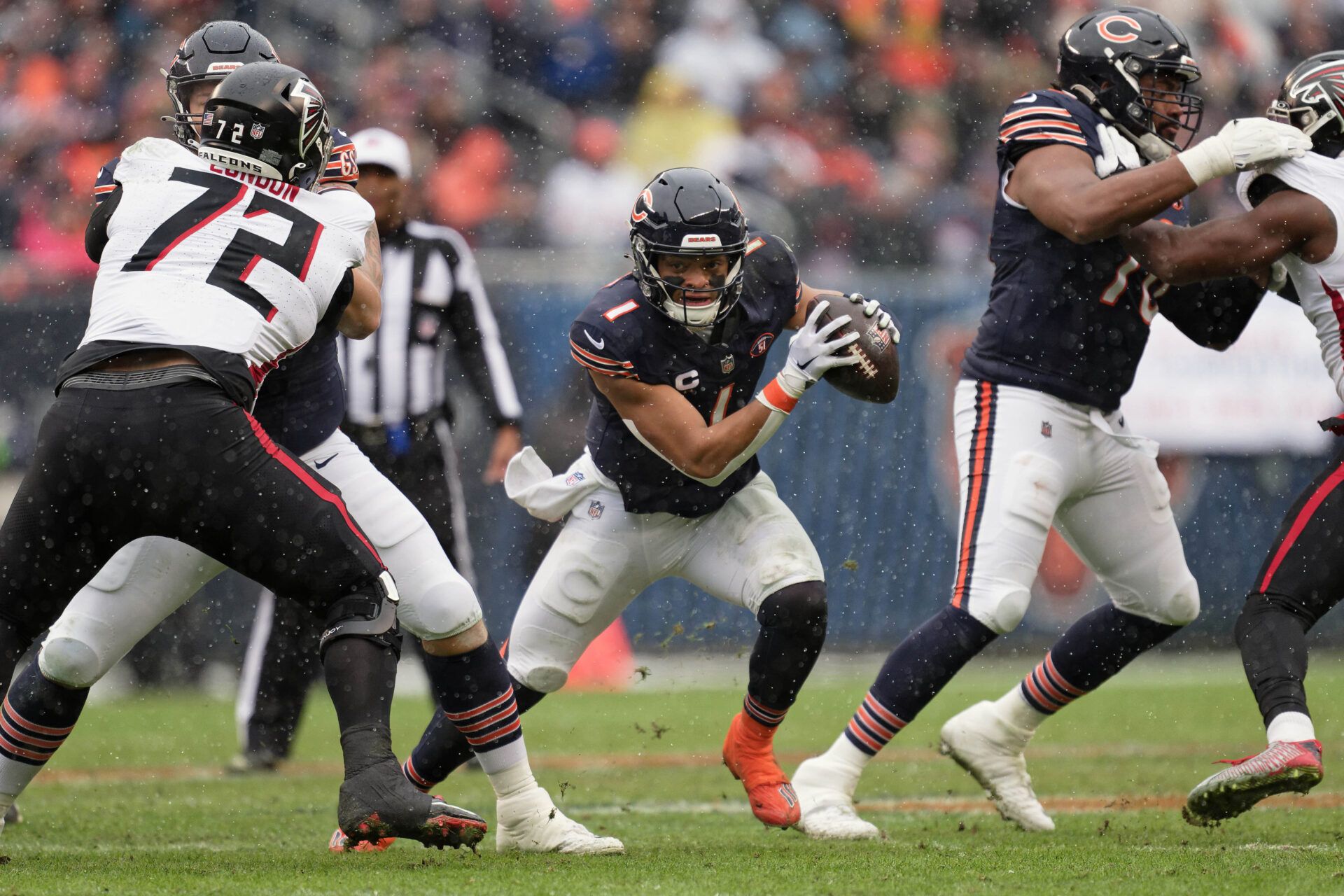 Chicago Bears quarterback Justin Fields (1) runs with the ball against the Atlanta Falcons at Soldier Field.