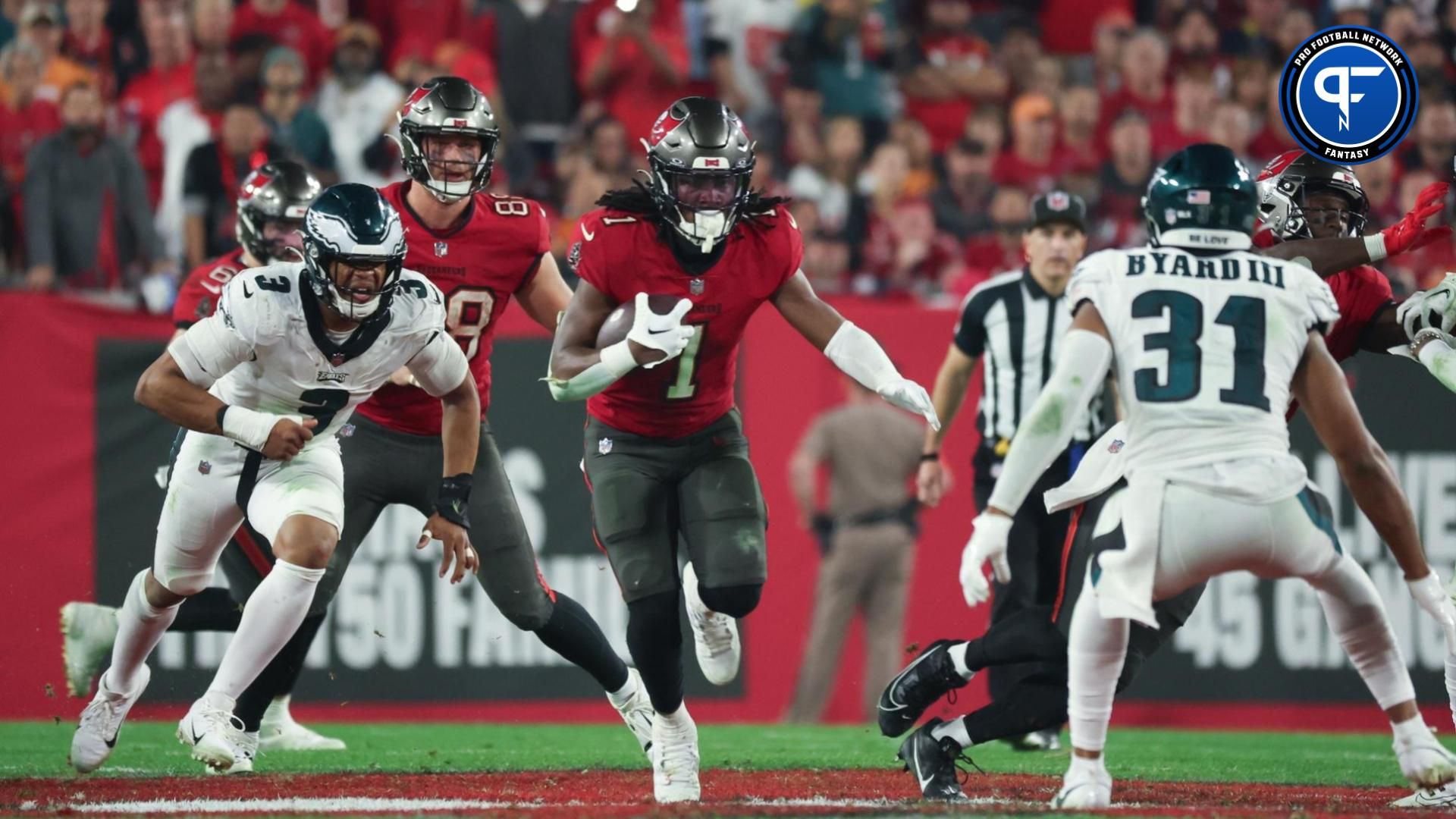 Tampa Bay Buccaneers running back Rachaad White (1) runs the ball against the Philadelphia Eagles during the second half of a 2024 NFC wild card game at Raymond James Stadium.