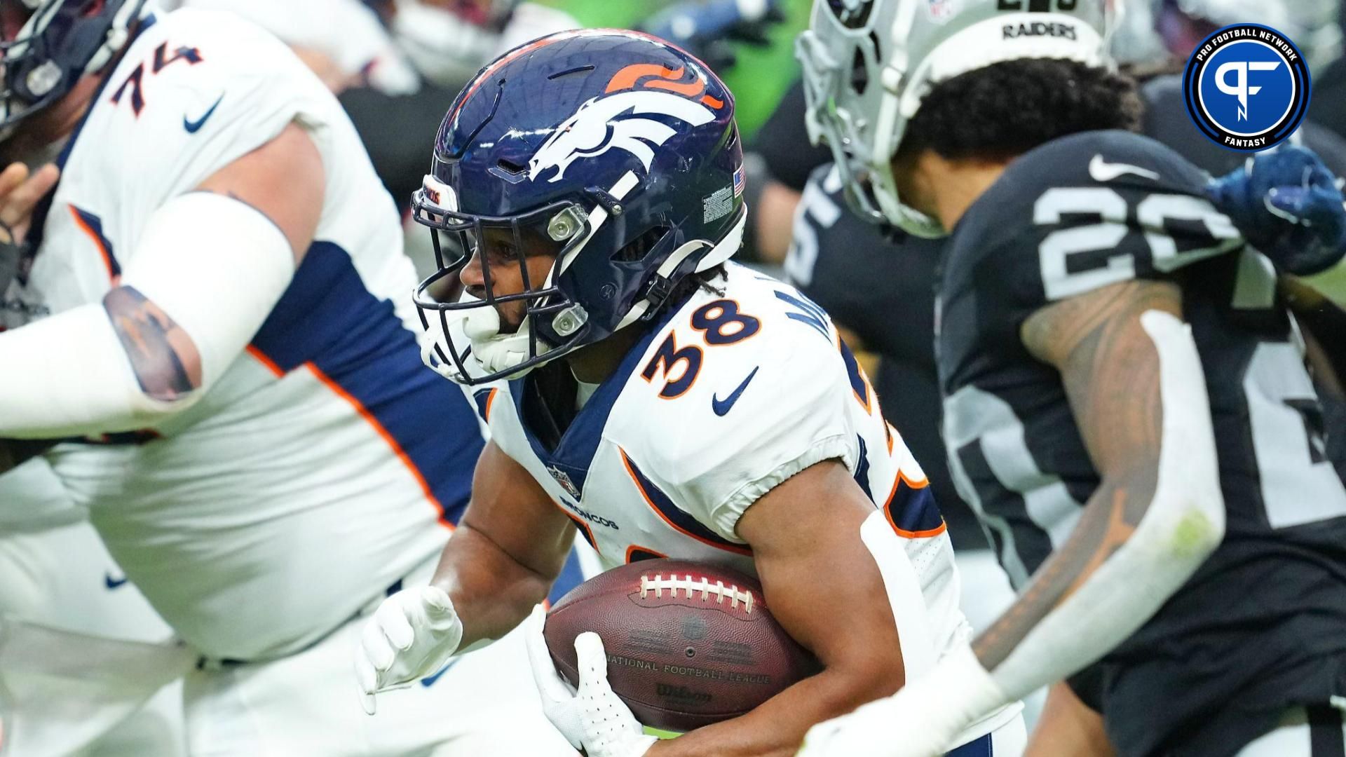 Denver Broncos running back Jaleel McLaughlin (38) rushes against the Las Vegas Raiders during the first quarter at Allegiant Stadium.