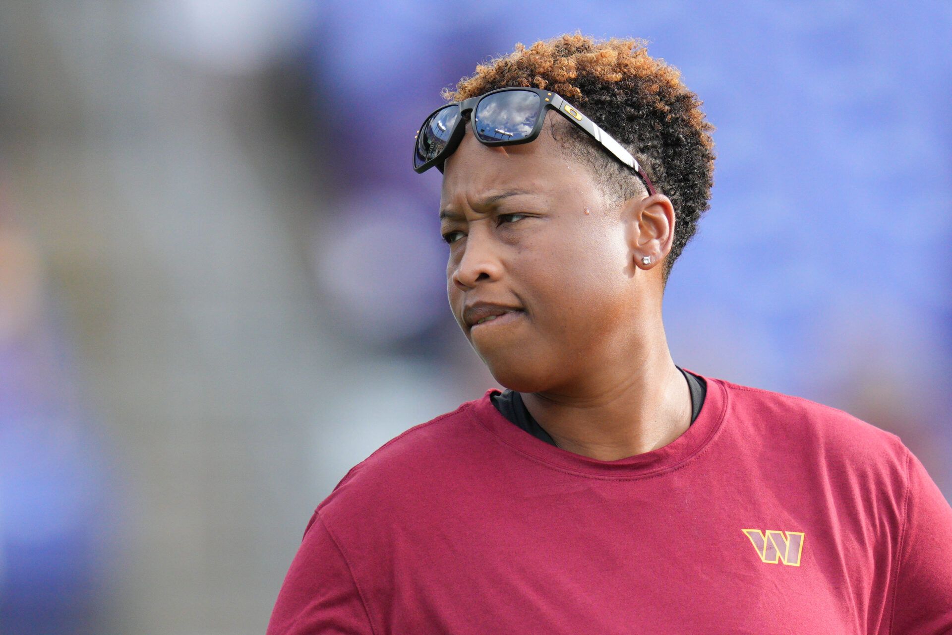 Washington Commanders assistant coach Jennifer King stands on the field before the game against the Baltimore Ravens at M&T Bank Stadium.