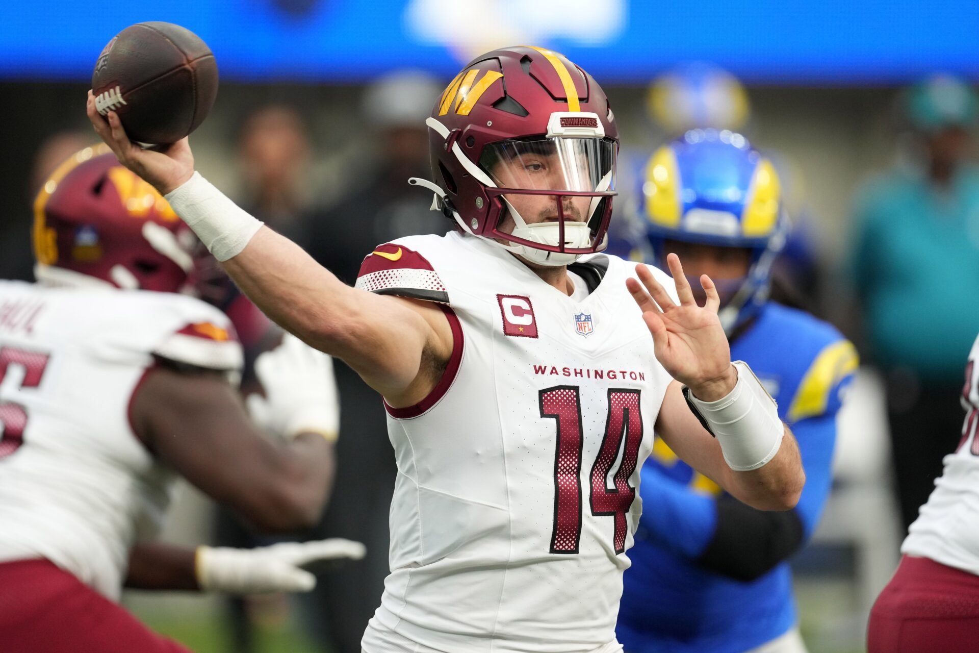 Washington Commanders quarterback Sam Howell (14) throws the ball against the Los Angeles Rams in the first half at SoFi Stadium.