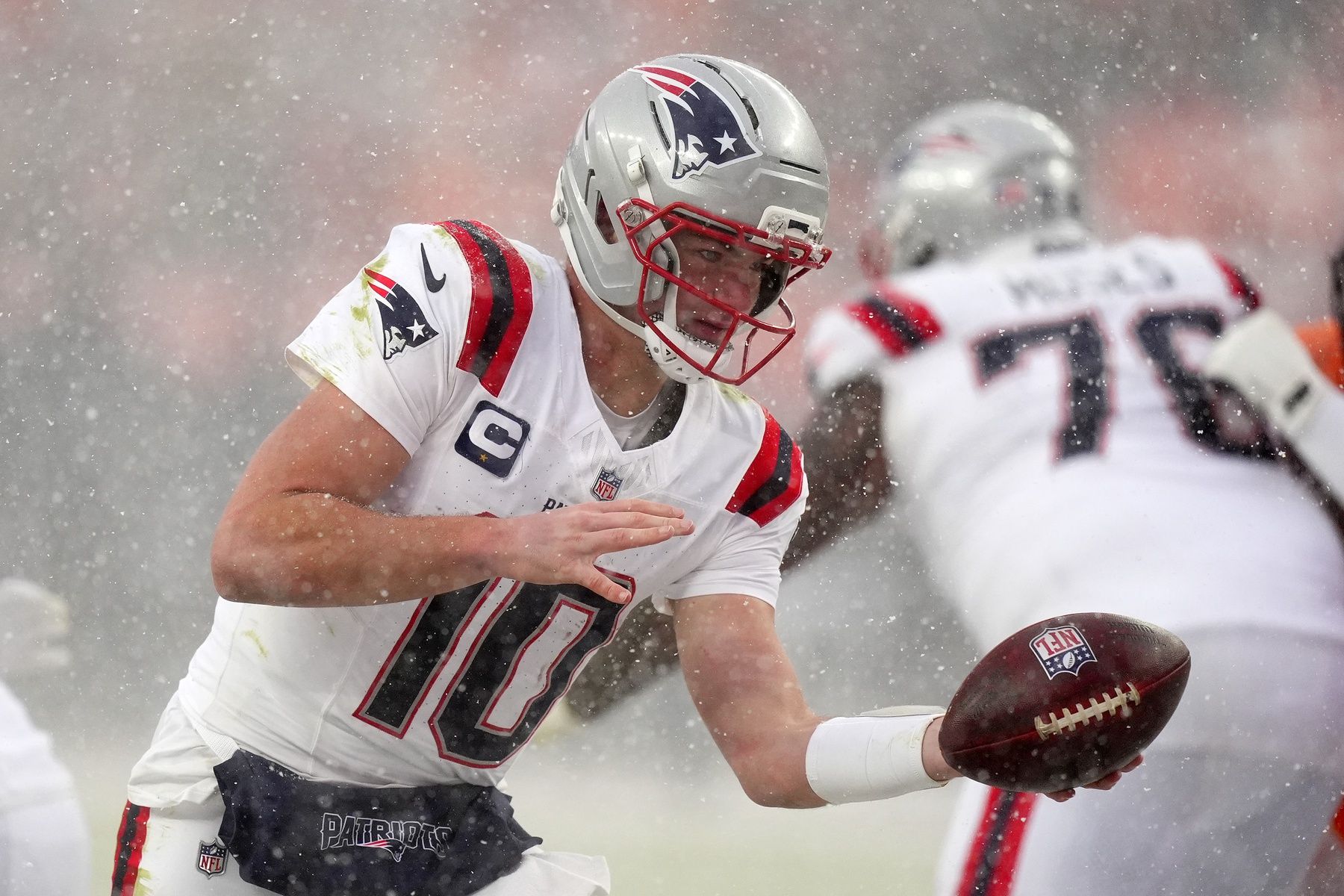 New England Patriots quarterback Drake Maye (10) prepares to hand the ball off against the Denver Broncos during the second half in the 2026 AFC Championship Game at Empower Field at Mile High.