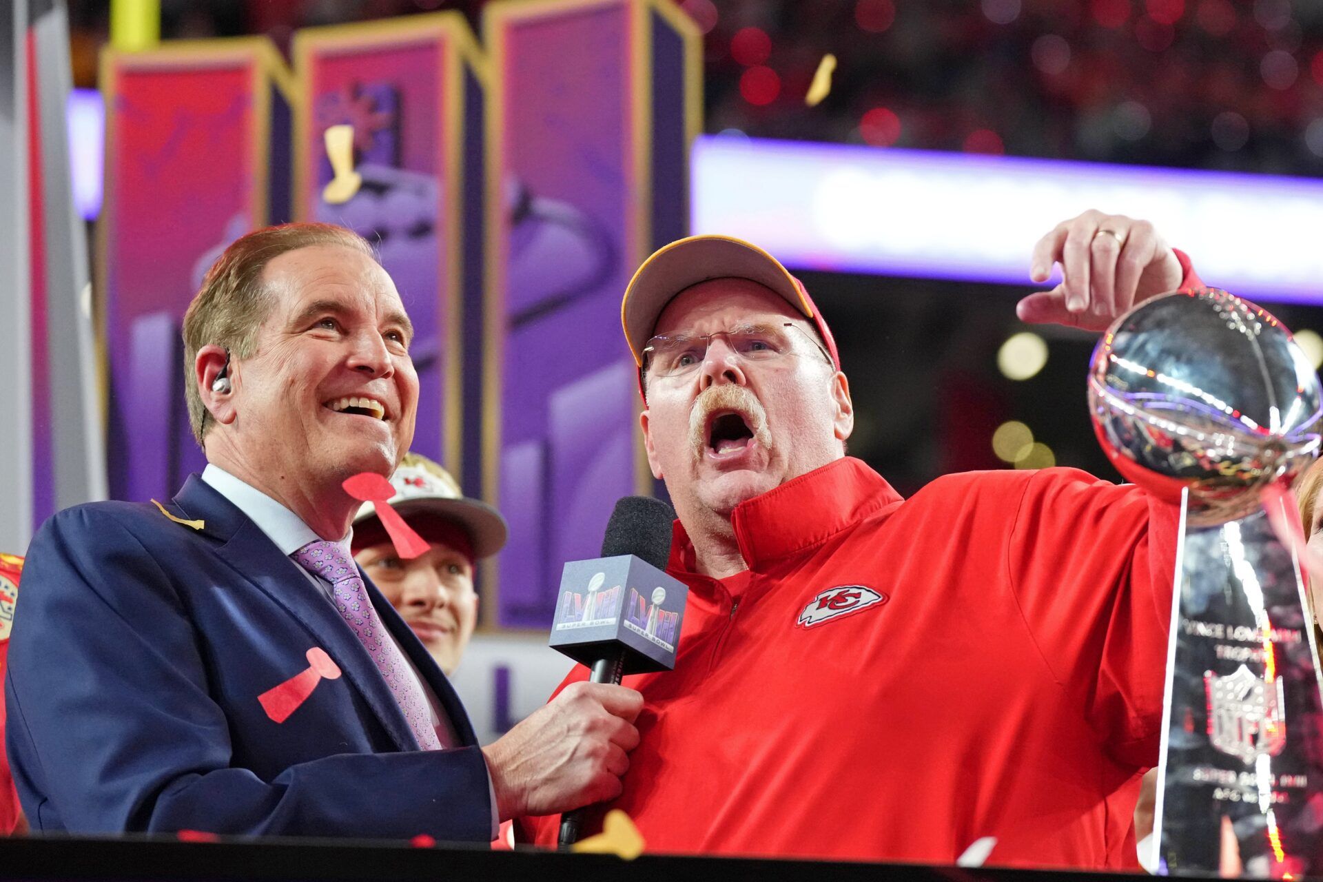 Kansas City Chiefs head coach Andy Reid celebrates while being interviewed by CBS commentator Jim Nantz after winning Super Bowl LVIII against the San Francisco 49ers at Allegiant Stadium.