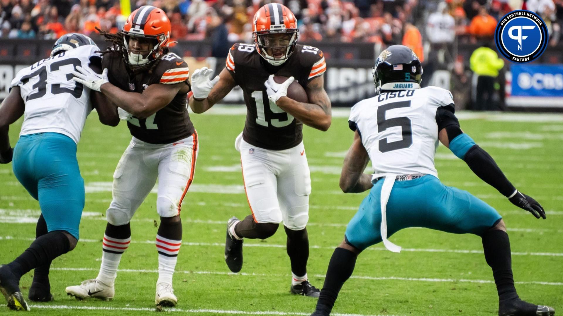 Cleveland Browns wide receiver Cedric Tillman (19) runs with the ball after a catch as Jacksonville Jaguars safety Andre Cisco (5) defends during the second half at Cleveland Browns Stadium.