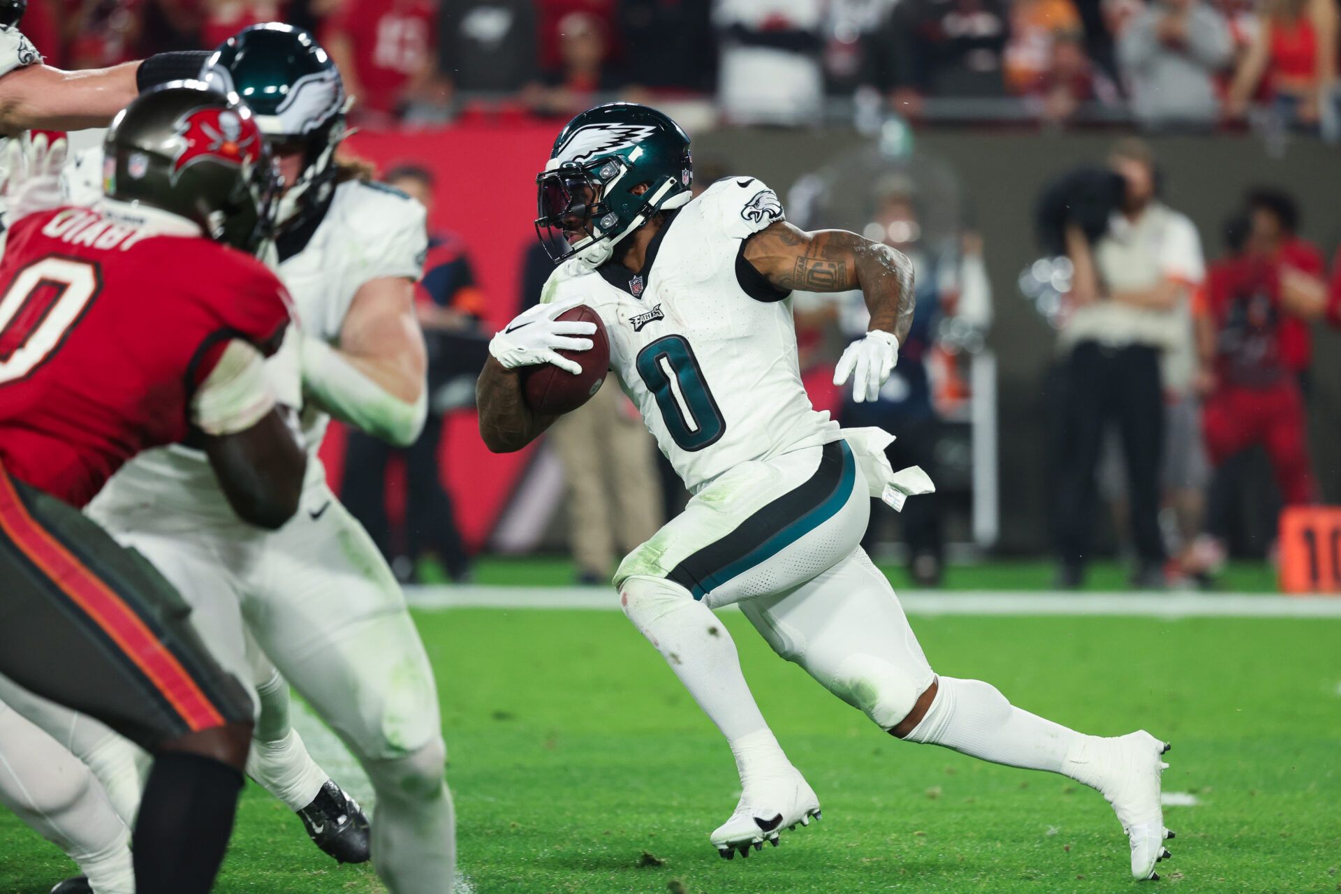 Philadelphia Eagles running back D'Andre Swift (0) runs the ball against the Tampa Bay Buccaneers during the second half of a 2024 NFC wild card game at Raymond James Stadium.