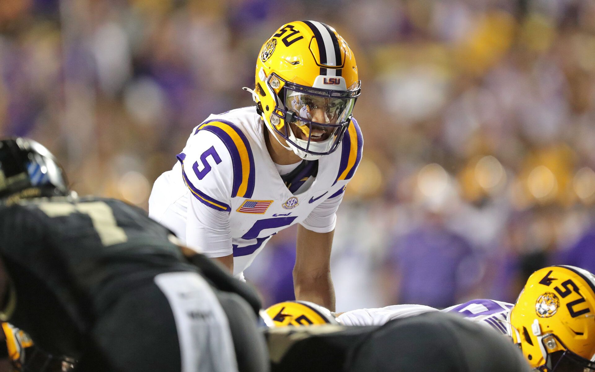 LSU Tigers quarterback Jayden Daniels (5) calls a play at the line against the Army Black Knights during the first half at Tiger Stadium.