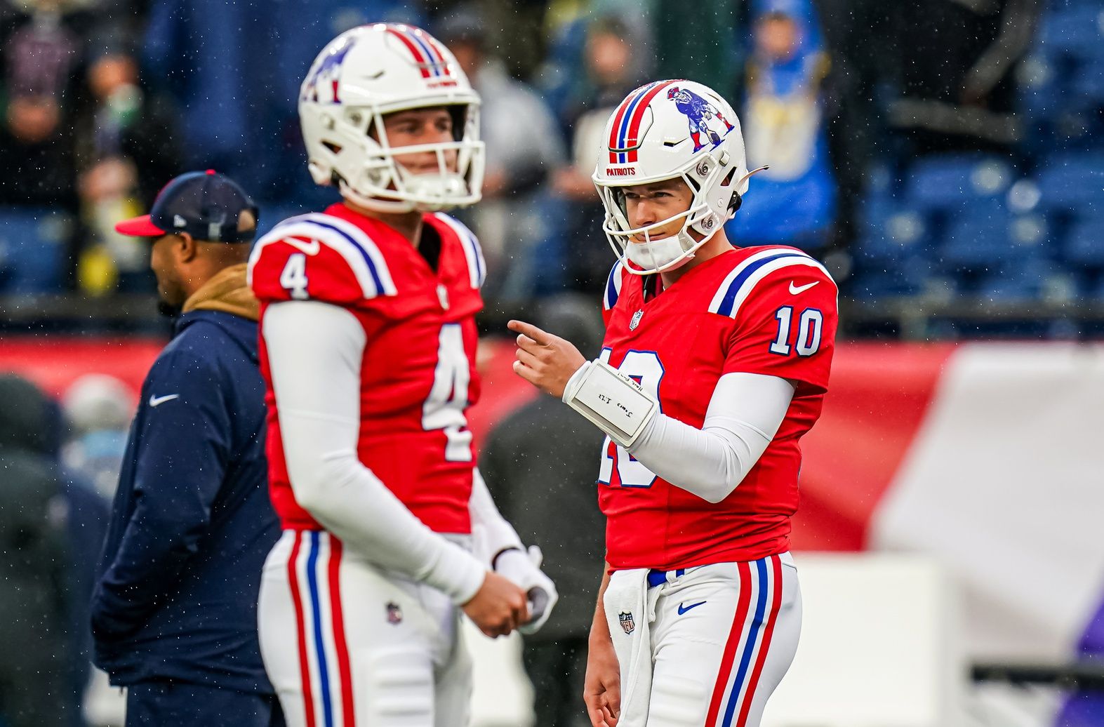 New England Patriots QBs Mac Jones (10) and Bailey Zappe (4) on the field to warm up before the start of the game.