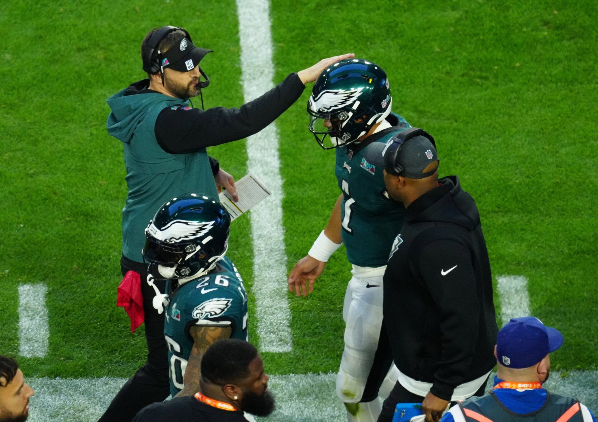 Philadelphia Eagles head coach Nick Sirianni pats QB Jalen Hurts (1) on the helmet after scoring a touchdown.