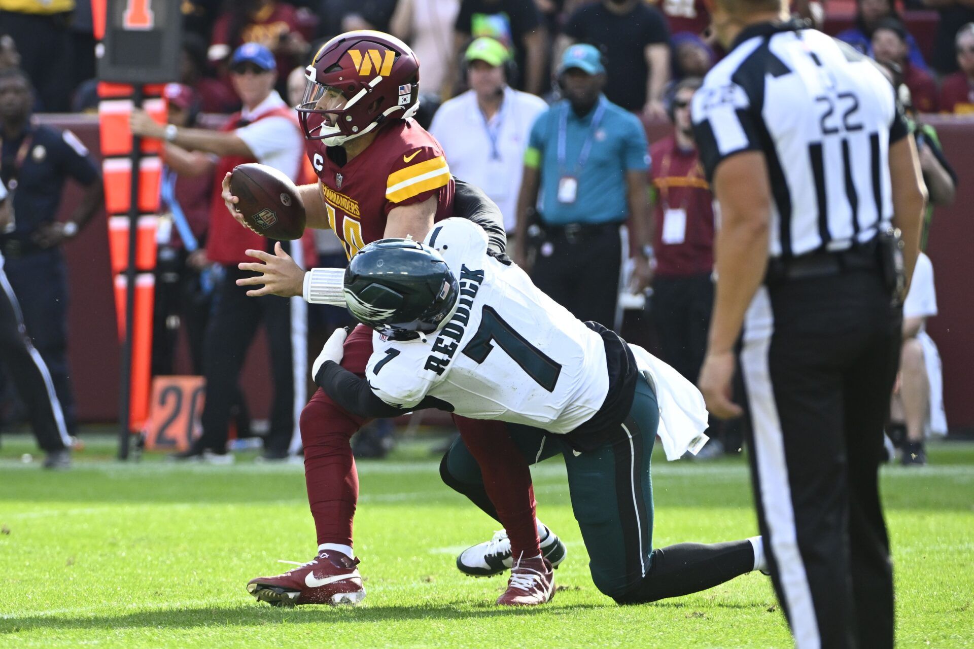 Philadelphia Eagles edge rusher Haason Reddick (7) sacks Washington Commanders QB Sam Howell (14).