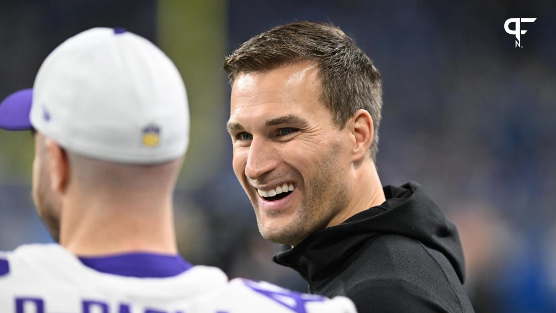 Minnesota Vikings quarterback Kirk Cousins (8) smiles with teammates prior to their game against the Detroit Lions at Ford Field.