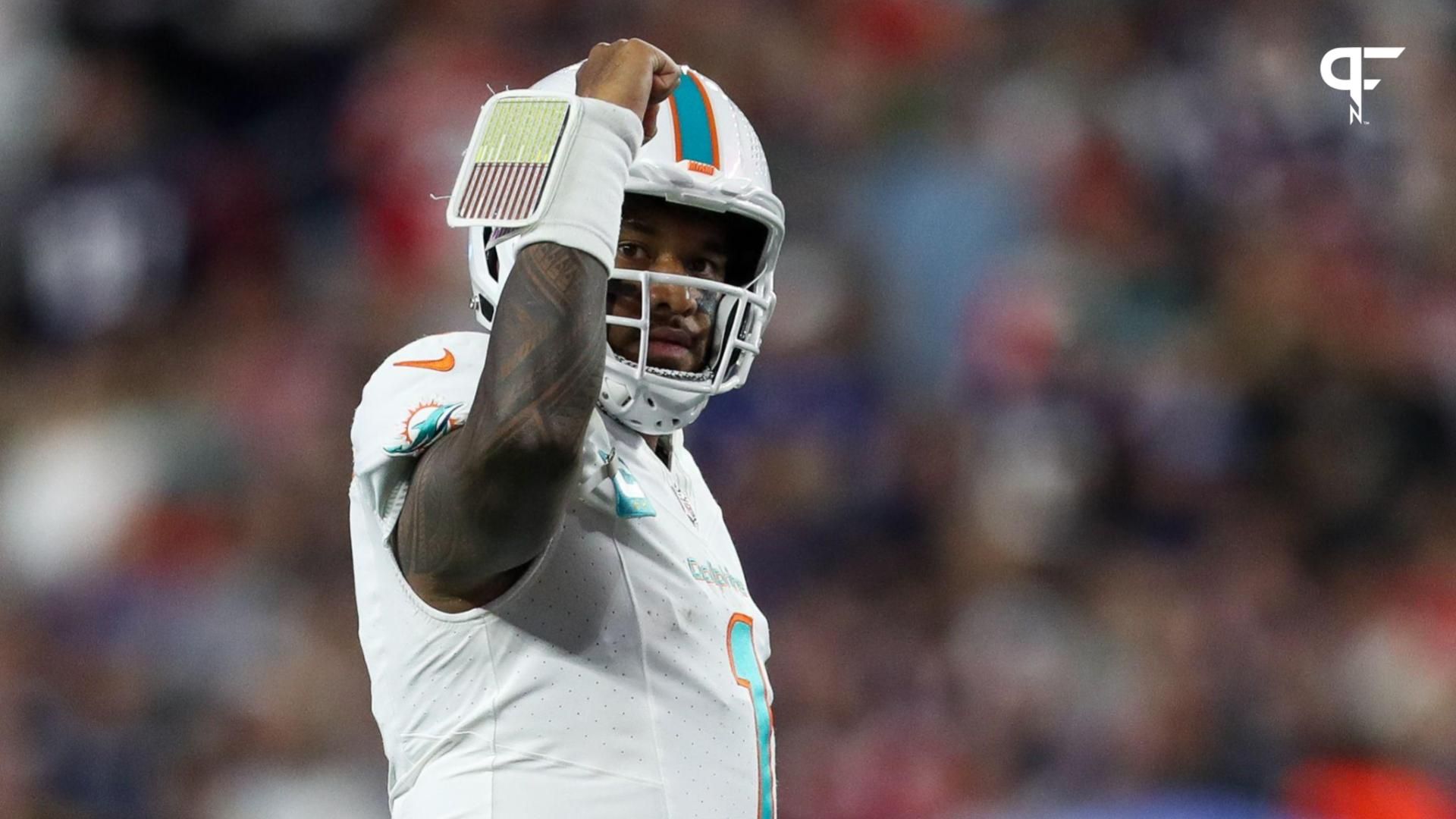 Miami Dolphins quarterback Tua Tagovailoa (1) celebrates after a touchdown during the first half against the New England Patriots at Gillette Stadium.