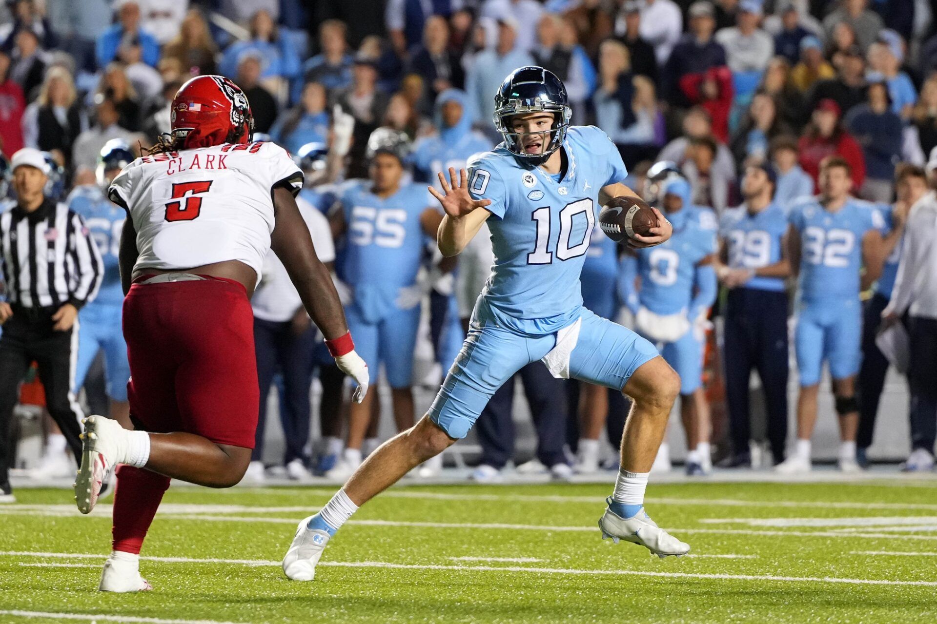 North Carolina QB Drake Maye (10) looks to avoid the rush against NC State.